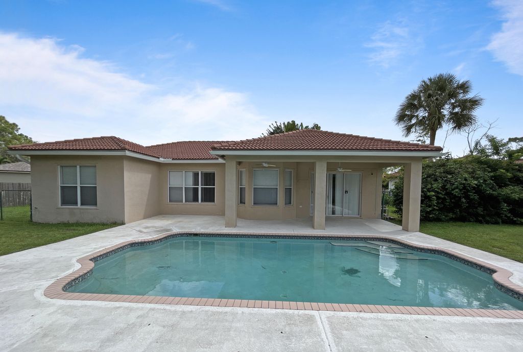 Photo of 124 Sycamore Drive, Royal Palm Beach, FL 33411 (MLS # R11009512)