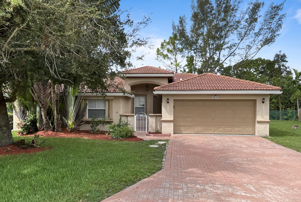 Photo of 124 Sycamore Drive, Royal Palm Beach, FL 33411 (MLS # R11009512)
