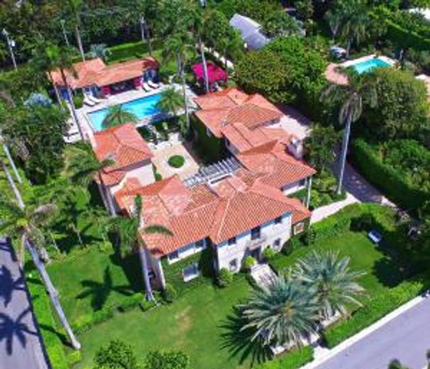 Extraordinary 1920’s Palm Beach estate with Intracoastal views. Beautifully renovated while preserving many original details including pecky cypress ceilings, doors, stone fireplaces, Cuban tiles and rare ironwork. Graciously situated on over ¾s of an acre, the newly landscaped property offers a private oasis surrounded by stunning grounds. This magnificent 6 bedroom/8 bath Mediterranean estate

features high ceilings, large living and dining rooms, gourmet kitchen, wood paneled library, separate pool house and private beach access. A rare find!