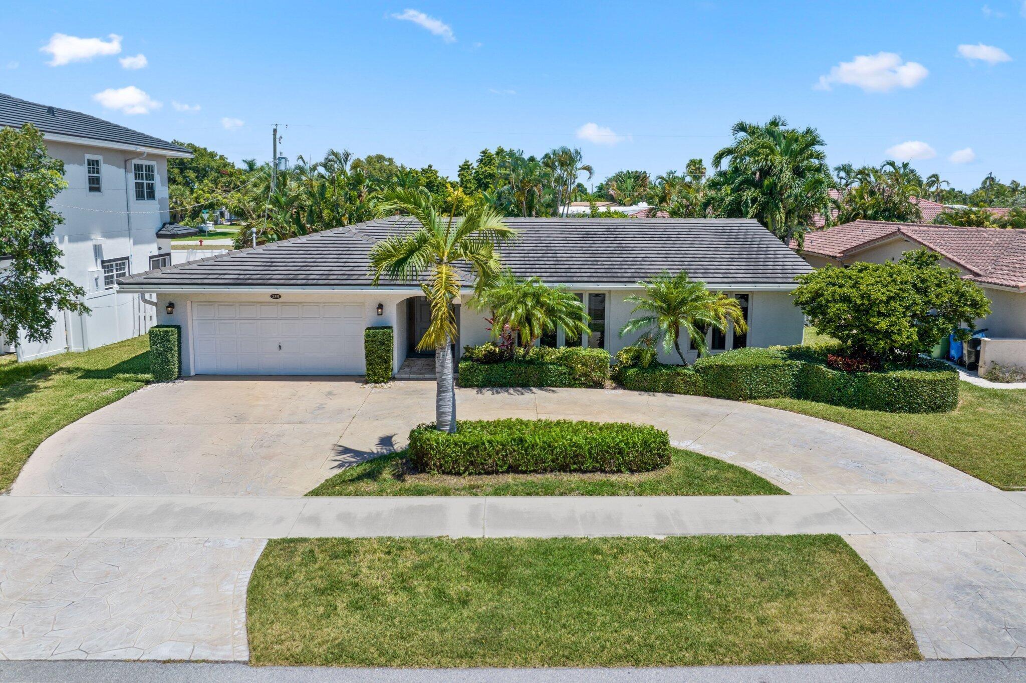 This beautifully maintained four-bedroom, two-bathroom split-bedroom home is located in the heart of Coral Ridge and offers exceptional style and comfort. At the center of the open-concept layout is a spacious kitchen featuring granite countertops and stainless steel appliances--both practical and functional, perfect for everyday living and entertaining. The home includes a formal family room at the front, along with a formal dining room, providing plenty of space for gatherings. Notable upgrades include a durable metal roof installed in 2020, along with hurricane impact windows and doors for added peace of mind. Step outside to your private outdoor oasis--an entertainer's dream--with a modern pool and elegant travertine flooring throughout the patio area. Make this exceptional home yours!