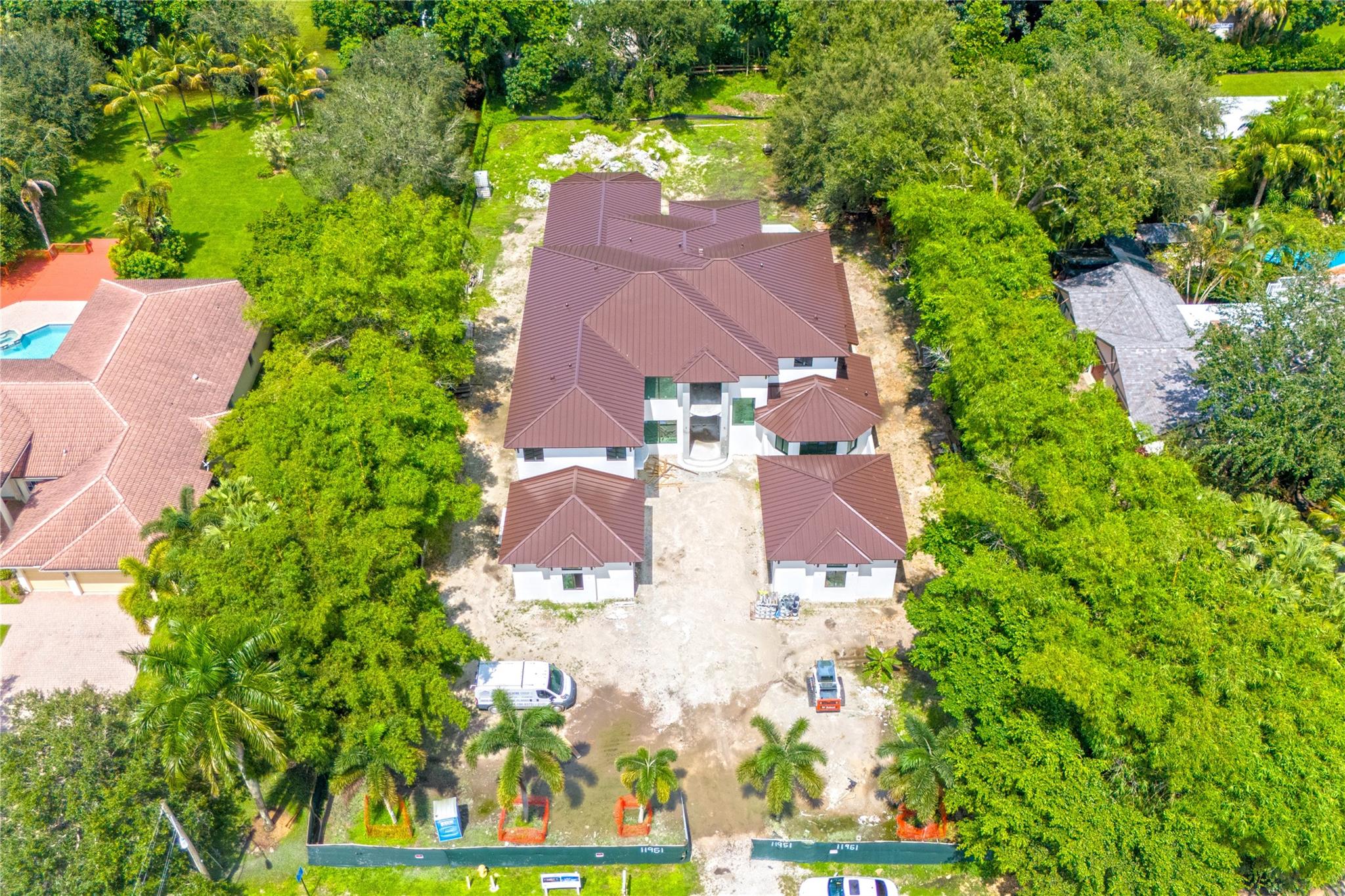 This exquisite New Construction home offers seven bedrooms plus an office, eight bathrooms, and 8,247 sq. ft. of refined living space. Walking through the custom 11-foot front door, you are met with direct views of the pool and a sense of spaciousness with 24 feet of ceiling height. There is a wine room just off the formal dining area and an elevator as you come in through the garage. Three upstairs rooms boast private balconies with serene backyard views. The primary suite is a true retreat, complete with double walk-in closets, a cozy sitting area, a huge master bath, and direct pool access. Other features include an air-conditioned garage, a complete summer kitchen, and a full cabana bath. Centrally located in Plantation Acres. Act quickly to personalize the finishes before completion!