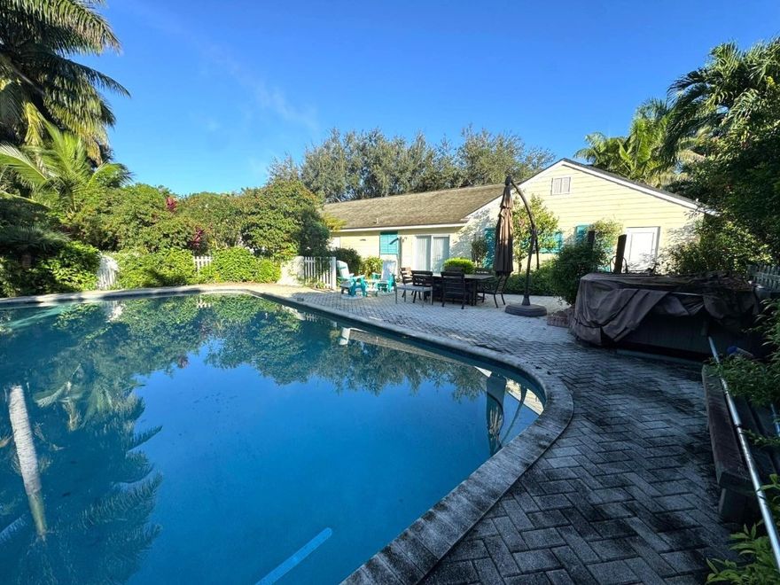 Discover endless potential with this rare 5-acre agricultural residential property featuring a 2-bed, 2.5-bath home, including an office/den, a massive steel outbuilding (2,761 SF), and a 1,620 SF carport that fits up to 4 commercial vehicles.The property also includes an irrigated palm tree farm/nursery. Ideal for nurseries, landscaping businesses, equestrian activities, or hobby farms with AG classification and AR zoning. The main home includes a spacious 2-car garage and an inground pool. Multiple parking options and open land for expansion and activities. Located in the heart of LoxahatcheeGroves — private, flexible, and ready for your vision.Located in the heart of Loxahatchee Groves — private, flexible, and ready for your vision.