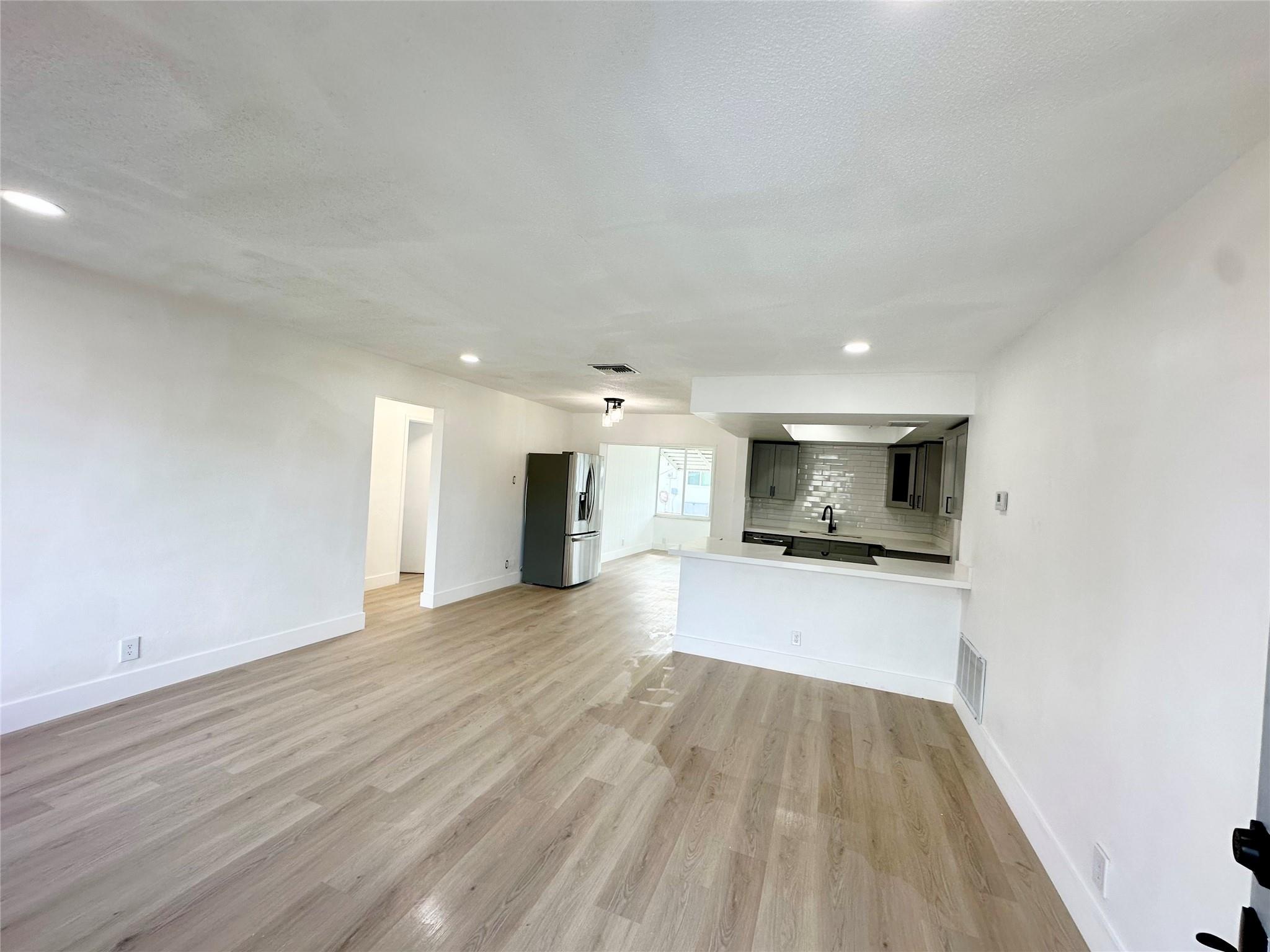 55+ community – Welcome to Mainlands of Tamarac! New roof in 2024. AC installed 2023. Well configured floor plan with nearly 1,400 sq ft. Nice sized yard with a peaceful garden view! Spacious 2/1.5 and easy convert the rear Florida room to a 3rd bedroom if desired. The bedrooms are on opposite sides of the home. One car garage and the driveway will fit an additional 2 vehicles. Recessed LED lighting in all living areas & kitchen, quartz countertops, newer stainless appliances, 100% waterproof vinyl plank flooring, updated GE electrical panel, newer water heater, the list goes on. HOA dues $100/mo. HOA requires 725 (or higher) credit score. Owner agent.