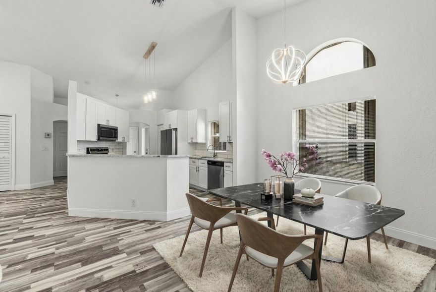 Beautifully updated 2 bedroom, 2 bathroom townhouse with 2-car garage and a new roof. The updated kitchen features white cabinets, granite countertops, and stainless steel appliances. Bathrooms have been renovated with new tile, fixtures, and vanities. Enjoy new luxury flooring throughout the home. Relax on the screened patio with a peaceful, scenic view—perfect for unwinding or entertaining. This property qualifies for a mortgage rate buydown of up to 3%!