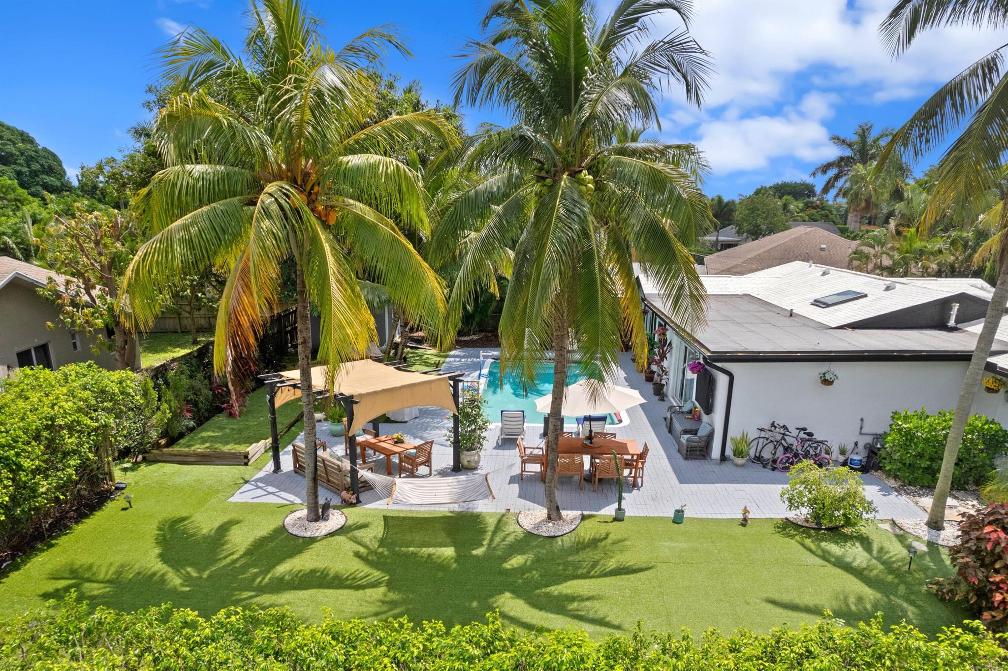 Tropical Paradise Oasis! This Fully Furnished, Turnkey Single-Family Home is in the Heart of Boca Raton's Most Desired Neighborhood of Hidden Valley! Dramatic Vaulted Ceilings, Skylights, Bright Open Split Floor Plan, Luxury Vinyl Floors & Recessed Lights! HUGE Stunning Updated Chef's Kitchen with Granite Counters, Breakfast Bar, Accent Lighting, 42' Cabinets, Wine Fridge & S/S Appliances! In Home Office! Immaculate Lush Fenced Backyard, Turf Grass, Landscape Lighting, Large Open Patio & Pergola, Custom Pool & Bocce Ball Court! Impressive Master Bedroom, Sitting Area, Barn Doors | Ensuite, Dual Sink Vanity, Jacuzzi Tub & Large Shower! In-Law Suite with Kitchen & W/D! 2 Sets of W/D! Bike to Beach & Park! Prime East Boca Location! A+ Schools! Minutes to Beach, Mizner Park, & Delray Beach!