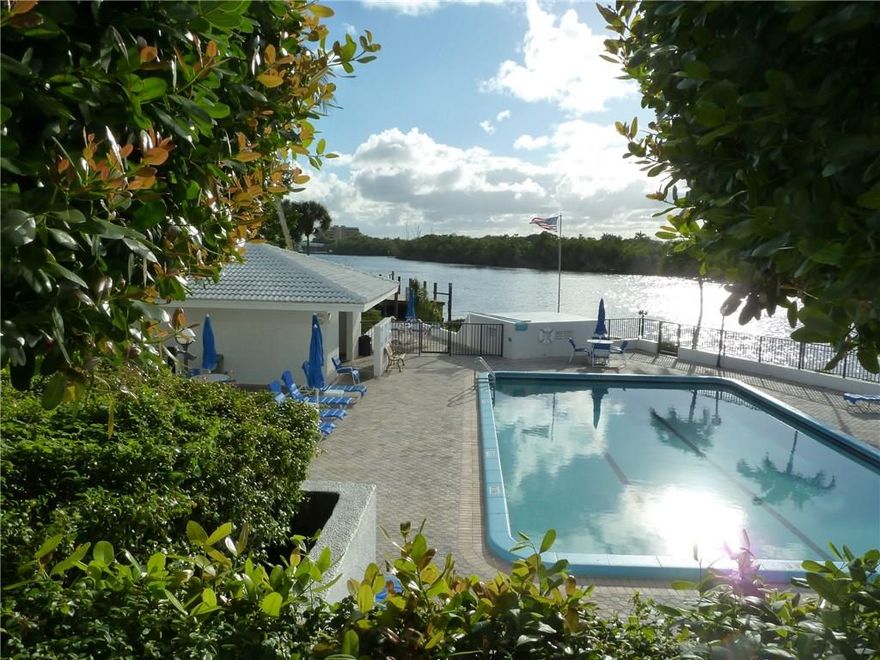 Enjoy the daily boat parade from your open balcony. This spacious 1 bedroom, 1.5 bath condo features cherry wood floors throughout, floor to ceiling new impact windows & gorgeous intracoastal views from every room! Amenities include pool on intracoastal, gym, tennis courts, sauna, Beach Club on the ocean with FREE WI-FI, grills & entertainment room. Manned gatehouse. Condo fees include cable, wifi & onsite property manager & your own garage spot. Dock space for rent upon availability.