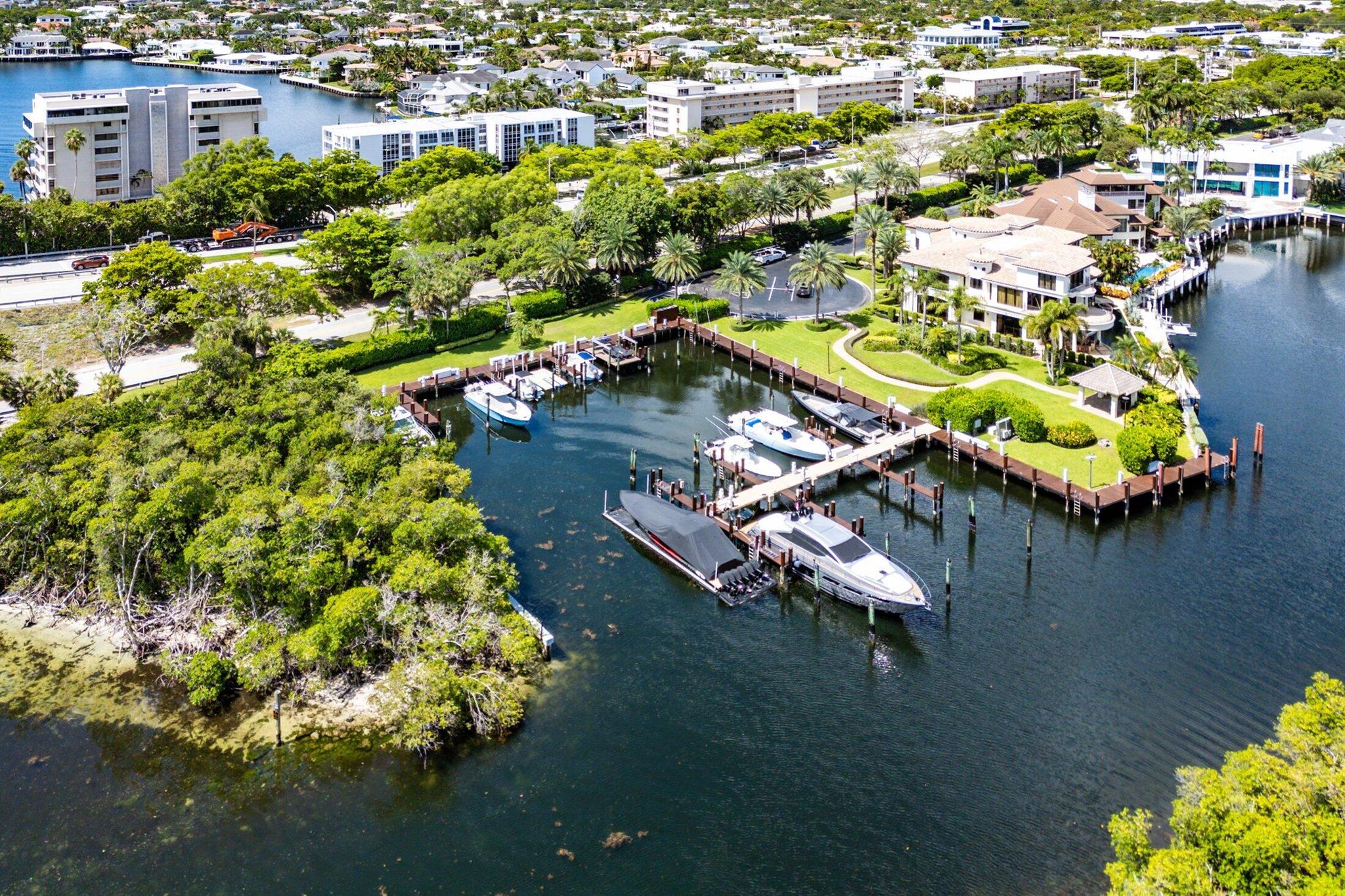 Nestled on a rare 16,552+/- SF lot in Boca Raton's most prestigious guard-gated waterfront community, The Sanctuary, this elegant 2-story residence offers 5,929+/- total SF of exceptional indoor-outdoor living. A circular drive and 3-car garage welcome you home to 4 spacious bedrooms, each with ensuite baths, plus 2 additional powder rooms, a formal dining room, family room, living room, eat-in kitchen, laundry, and versatile den.