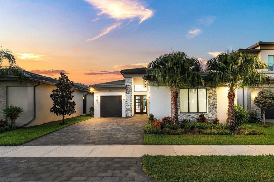 Perfectly finished 3BD plus den/office, 3.5 BA and a 3-car garage is truly move-in ready, this exceptional Bermuda model residence is located in the prestigious Lotus Palm community of Boca Raton, offering refined one-story living with modern architecture, thoughtful design, and an extraordinary level of customization. Built as new construction and enhanced with substantial builder and post-closing upgrades, this home delivers a rare combination of luxury, functionality, and comfort. The residence is situated on a prime cul-de-sac lot with partial lake views and an exceptionally oversized backyard, providing a peaceful setting with added privacy and flexibility for outdoor living. The expansive yard offers ample space for entertaining, play, making it one of the more desirable lots  here.