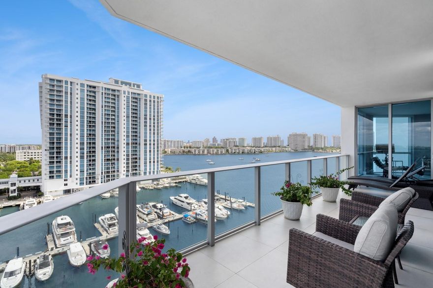 Residence 1101 at The Reserve at Marina Palms a truly special corner unit offering significantly more square footage than comparable 2Bedroom lines, plus a versatile den or home office, two full baths and a powder room. Wrapped in walls of glass, this upper floor home boasts panoramic views of the intracoastal and marina, creating a stunning backdrop from every angle. Sophisticated, and serene, the residence features custom Snaidero cabinetry, gleaming quartz counters, and premium Wolf appliances that elevate the designer kitchen. Every finish reflects meticulous attention to detail and timeless taste. The open layout, generously scaled rooms, and thoughtful floor plan make this a true standout perfect for both elegant entertaining.