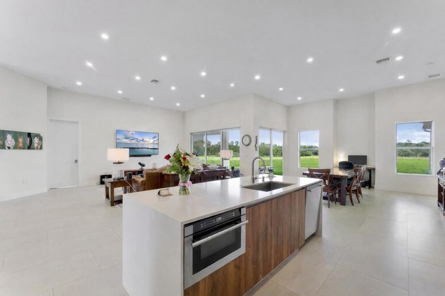 NEW CONSTRUCTION equestrian retreat set on cleared, elevated land, backing to a protected bird sanctuary with a private entrance to miles of horse trails. The 2023 built modern home offers 4 bedrooms plus an office/ den, 3 full baths, hurricane-impact windows and doors, a new upgraded A/C, and a whole-property reverse osmosis water system. Horse facilities include a NEW 2024 European-style barn with twelve 12' x 12' stalls, ceiling fans and stall fans, and 7 stalls have 48-ft runs and gated access for easy turnout. The property also features six oversized 46' x 46' paddocks, additional 12' x 46' gated paddocks, and connected paddocks with gates allowing for flexible group turnout. Two wash racks, tack and feed room, bathroom and mudroom. Quiet and private, with two separate driveway and RV hook up. Located in a gated equestrian neighborhood, just off of Southern Blvd by Wellington Showgrounds- IDA, WEF, White Fences, Polo Center. Zoned for Wellington's A Rated schools!