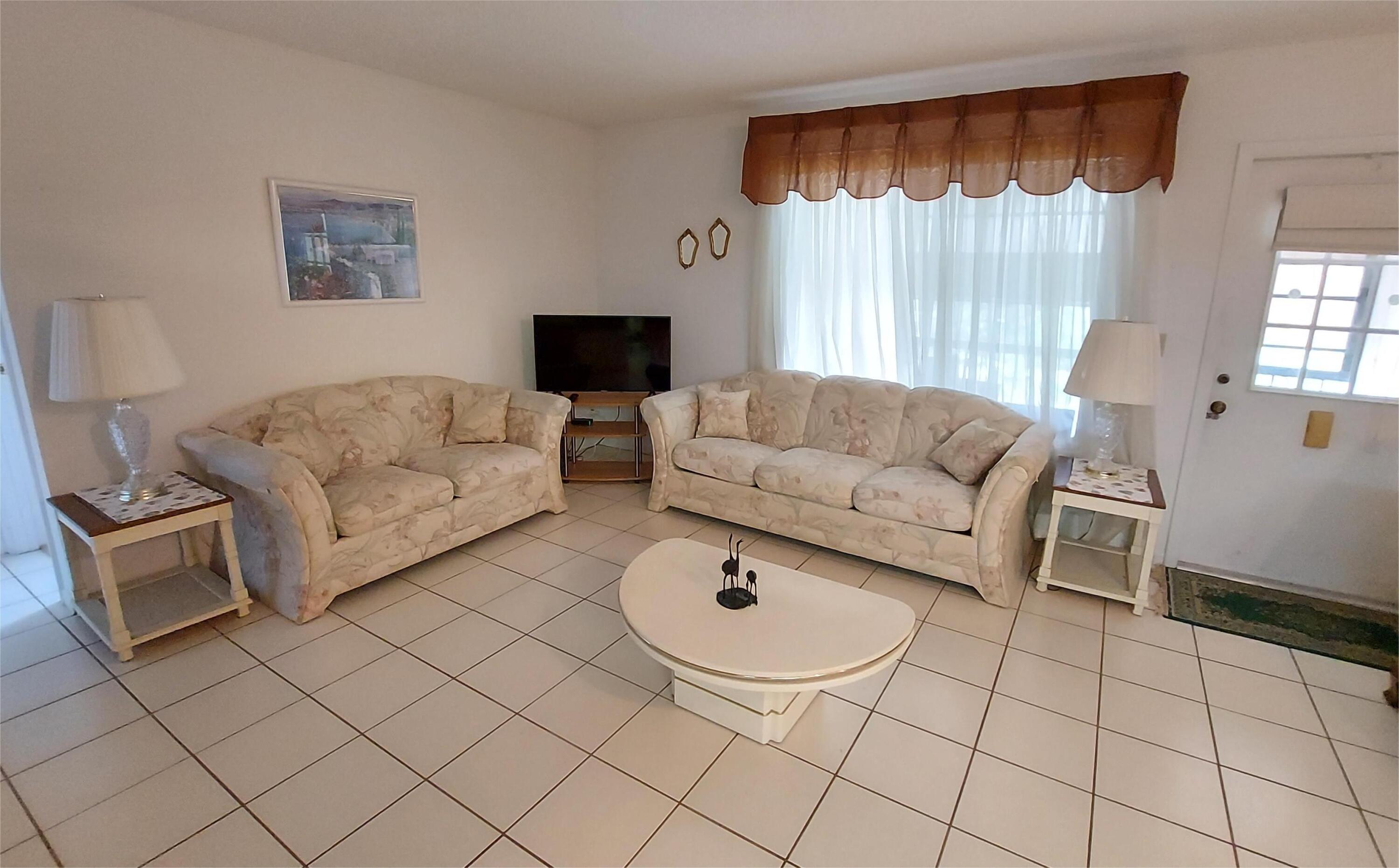 Welcome to this charming 2 bedroom, 2 bath condo located in a desirable 55+ community! Situated on the 2nd floor, this home features beautiful laminate flooring throughout, spacious walk-in closets in both bedrooms, and a convenient laundry room with washer and dryer included. Enjoy your morning coffee or evening breeze on the screened-in porch. This beautiful , quiet community offers clubhouse, pool, shuffleboard and bocce ball. It's close to restaurants, shopping centers and parks. This well-maintained unit offers comfort, convenience, and a vibrant community lifestyle.