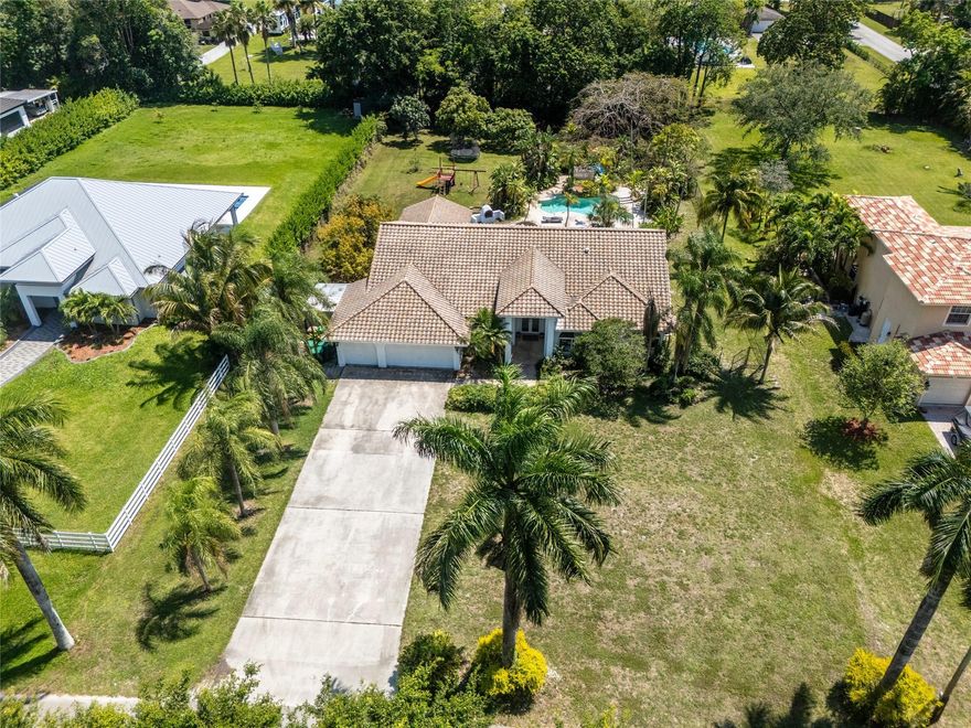 WONDERFUL ACRE HOME! PRIVATE CUL-DE SAC ST! IMPACT WINDOWS & DOORS! 4YR OLD  BARREL ROOF WITH POLYGLASS UNDERLAYMENT & FOAM! SPLIT PLAN OFFERS DOUBLE DOOR FOYER ENTRY, SUNNY, OPEN LIVING SPACES, WOOD FLOORS, WOOD LOOK CERAMIC TILE IN BEDRMS & HIGH CEILINGS! LGE MAIN SUITE, 2 WALK-INS, DUAL VANITIES, ROMAN TUB PLUS 4 NICE SIZED BR'S, 1 CAN BE OFFICE, HAS A CLOSET. UPDATED BATHS, 1 IS CABANA! HUGE ENCLOSED PATIO 650 SF, GREAT FOR HOSTING LARGE PARTIES, PLAY AREA, HOME SCHOOL ETC. 3 CAR GARAGE! TROPICAL DEEP YARD-ROOM FOR BIG TOYS & HORSES. MANY MANGO TREES! FREEFORM POOL, ROCK WATERFALL & SLIDE. EXCELLENT SCHOOLS INCL COUNTRY ISLES ELEMENTARY IN WESTON! ACCESS DAVIE'S AMAZING REC. TRAIL SYSTEM, I-75 & 595,WESTON TOWN CENTER, SAWGRASS MALL, CLEVELAND CLINIC, HOUSES OF WORSHIP ALL MINUTES AWAY