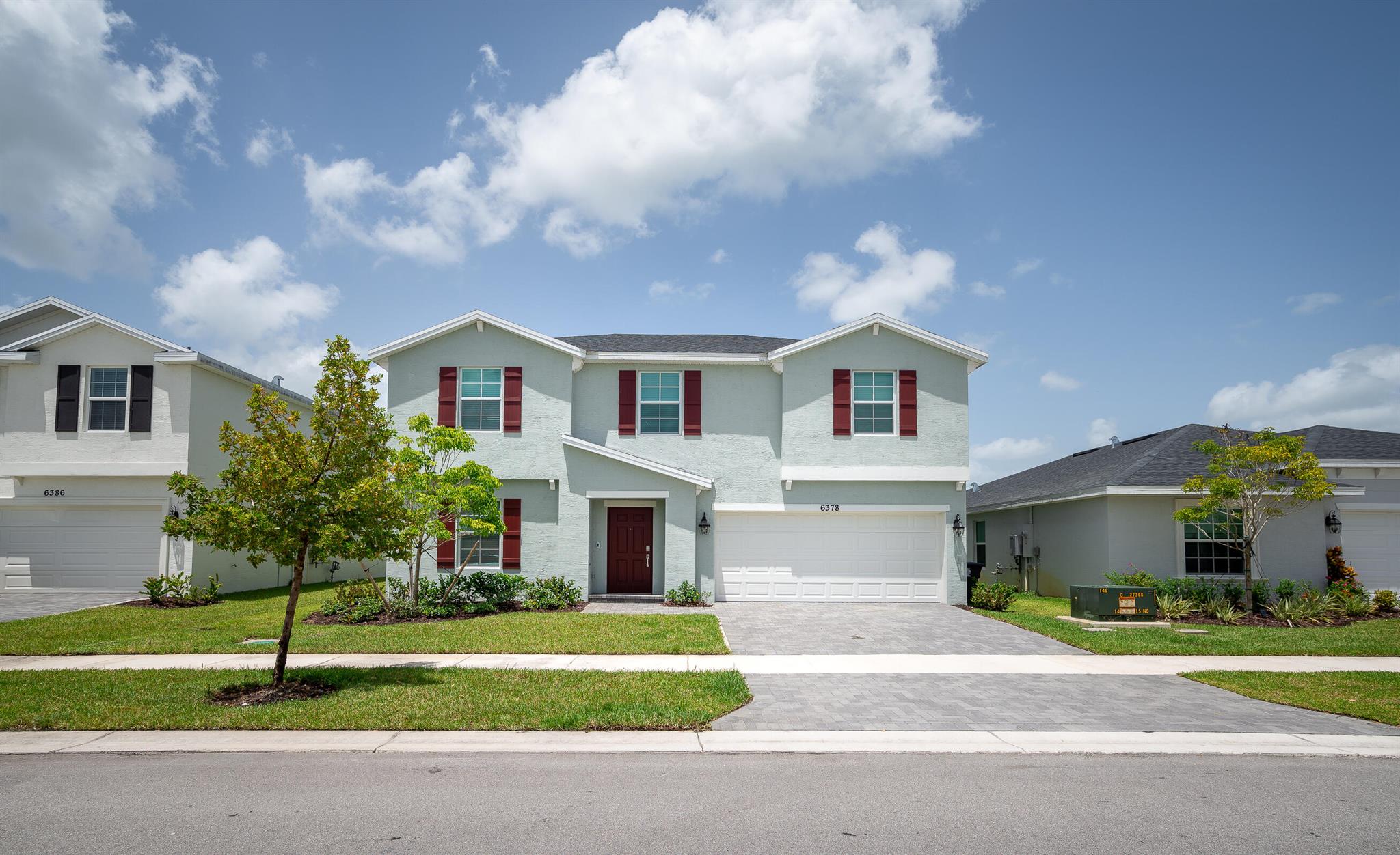 Brand new and beautifully designed 5-bedroom, 2.5-bathroom home with an additional flexible den/office offers 2,908 sf under air (3,497 total sf) of inviting living space, featuring hurricane impact windows, a spacious fenced backyard with stunning lake views, a pavered driveway, and a full two-car garage. The open-concept main level is anchored by a stylish kitchen with stainless steel appliances, smart refrigerator, gas stove, elegant quartz countertops, and a generous pantry--perfect for everyday living and effortless entertaining. The first-floor primary suite offers a peaceful retreat with a large en-suite bath and a beautifully designed walk-in closet that provides abundant storage with built-in drawers, open shelving, and multiple hanging rods to keep everything organized...