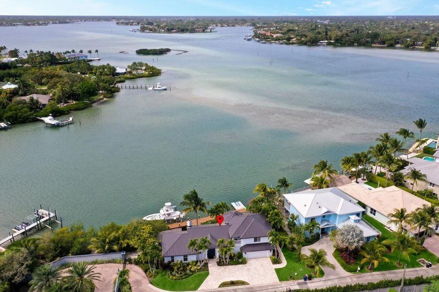 If you love the beautiful blue/teal/aqua colored breathtaking water, boating, paddle boarding, fishing in your backyard, watching the sunsets. or just being in the water, this property is for you. Welcome to paradise! This home is situated in an exclusive gated community consisting of only eight homes. When you enter the home, you will be greeted by breathtaking views of the Loxahatchee River. The Jupiter Inlet is just minutes away from this home, truly a boater's dream. Experience spectacular sunsets from your backyard as you take in the water views. Click the link under the main photo for the 3D Tour and videos.