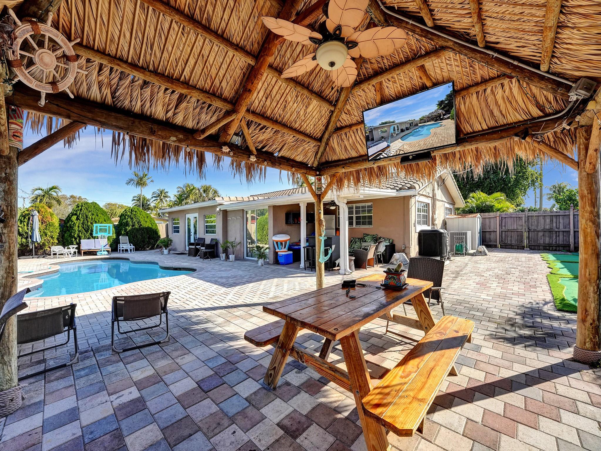 Located in East Deerfield Beach, this charming home sits on a MASSIVE corner lot, minutes from the beach,
downtown Boca Raton, steps from The Cove and parks with boating & splash pad amenities. Featuring modern
comforts like an oversized Patio, Large Heated Pool, Oversized Tiki hut & entertainment, Putting Greens, Game
Room, spacious yard, garage, updated appliances, stunning remodeled bedrooms & Bathrooms and more! This
tropical retreat embodies Florida living. Walk to the beach, Bike to the beach or just stay home & have a staycation! NO HOA, NO RESTRICTIONS & can come fully furnished! This home has amazing AIRBNB reviews & comes with property managers that manage the Airbnb. This home produces HEALTHY revenue per month & allows Boat/ RV parking. Amazing Dog Friendly neighborhood!