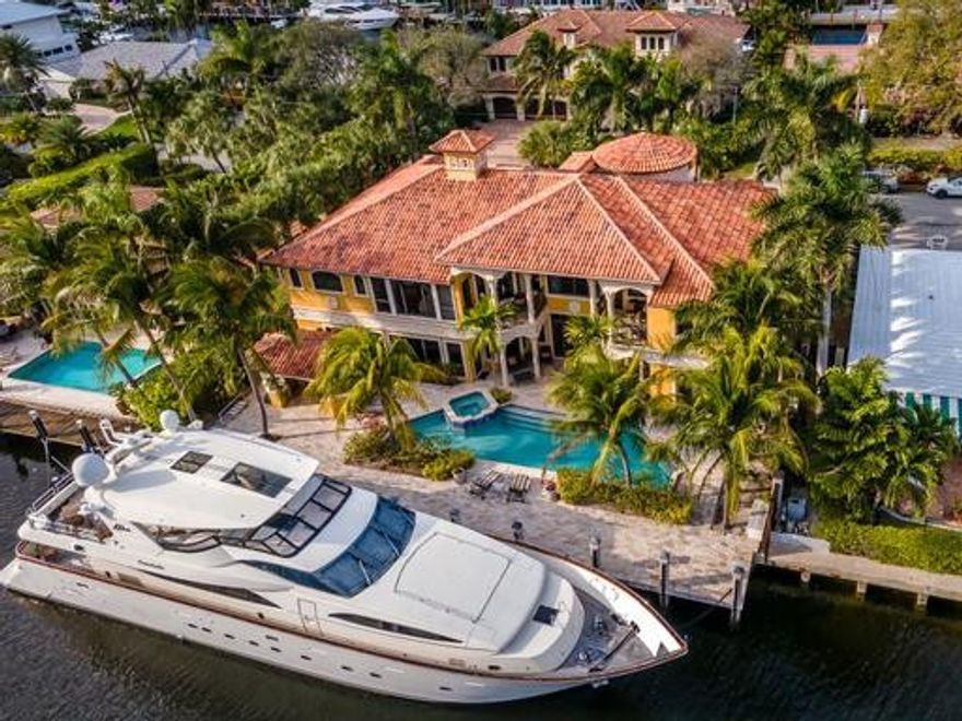 Luxurious Custom Mediterranean Waterfront Mansion in Coral Ridge! This Property Features a Total of 6,823 Sq of Amazing Finishes and Wonderful Attention to Every Single Detail. From a Gazebo Summer Kitchen to a Custom Built Library and A Spacious Theater Room. Golden Marble Floors in Living Areas and Brazilian Hardwood floors in the Bedrooms. This Home Offers 4 Car Garages, Elevator, Wine Cellar, Impact Glass, Salt Water Pool, 100 Ft on the Water with an Extended Concrete Dock. Kitchen With Double Granite Countertops, Tumble Marble Backsplash, Gas Stove w/Electric Griddle, Sub Zero Freezer and Refrigerator and More. Majestic Curved Marble Staircase, Remote controlled Fireplace w/Precast Columns All The Way To The Ceiling. Master Bedroom with a Fireplace,His and Hers WIC and LOTS of Space.