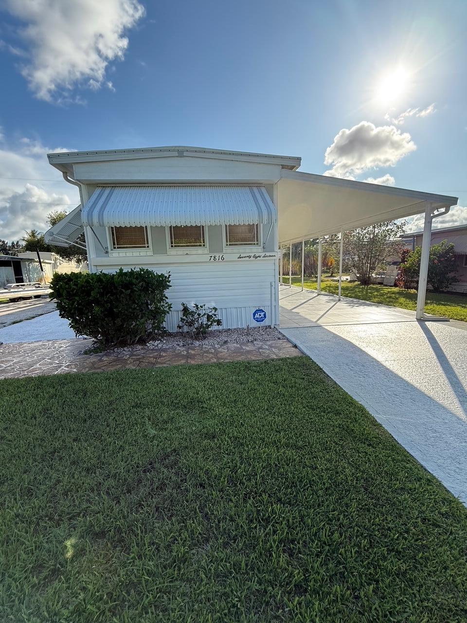 Welcome to your fully furnished 2-bedroom, 1-bath mobile home retreat with stylish updates and a light coastal flair. This charming property features an updated kitchen and baths, newer appliances, a brand-new roof and A/C system installed in 2023, and an enclosed sunroom with portable A/C units for extra living space. The detached laundry shed offers additional storage and a built-in workbench, while the carport and patio provide ideal spots for relaxing or entertaining. Located just 10 minutes from downtown and about 5 minutes from the beach, this turnkey home makes for a perfect year-round residence or vacation escape--just bring your suitcase and settle in.