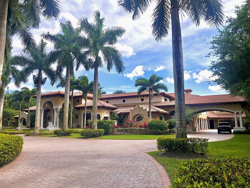 Elegance abounds at 6025 Le Lac Road in Boca Raton's ultra-private gated community of Le Lac, once ranked by Forbes in the top 10 gated U.S. neighborhoods. This magnificent 2.5 acre waterfront estate is an architectural masterpiece showcasing a grand 100' gallery, with soaring groin vaulted ceiling, lined by imported carved limestone columns, authentic Venetian plaster and classic polished marble flooring.  Perfect for showcasing an art collection and entertaining. This classic estate home has lavish finishes, attention to detail and outstanding craftsmanship. Features include a movie theater, gym with sauna, wine cellar, multiple wet bars, epic pool lined with fountains backed by spectacular slides, cabana with outdoor kitchen, batting/golf cage, and 5 car garage with limousine stall