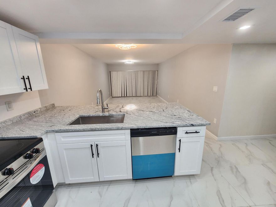 This oversized 1 bedroom (1000 sqft) 2 bathroom (1 full size bathroom and 1 guest half bathroom) has been completely remodeled with permits (NEW kitchen, bathroom, ceiling lighting, electrical, flooring, etc). 2 walk-in closets both with built in cabinets. Floors are tiled throughout. Kitchen is made for entertaining with large peninsula and new appliances. Kitchen is made of durable maple wood with 3/4" boxes 1/4" backs raised panel soft close doors and drawers. New A/C unit, New Water heater, new LED light fixtures and LED recessed lighting, new smoke detectors, new door handles and hinges, new closet bi-fold doors, tiled screened patio overlooking the pool area. Corner unit. New window treatment. This is a move-in ready home.