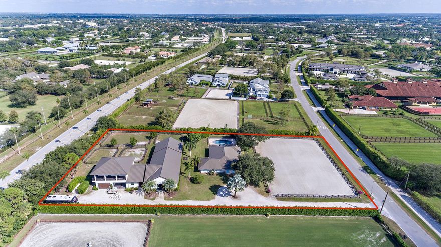 One of the finest turn-key equestrian facilities in the heart of Saddle Trail and 5 Minute hack distance to the Palm Beach International Equestrian Center!! This property offers four bedroom main house with separate efficiency apartment with a separate entrance. French doors off the master bedroom lead to the heated pool with jacuzzi. The barn features ten stalls with separate tack and feed room, owners lounge, two large wash/grooming stalls, separate laundry for barn, two oversize garage areas, two separate one bedroom, one bath staff apartments are located above the garages and an underground self-irrigated world class sand arena 100 X 175. Never miss a day of training because of the rain!
