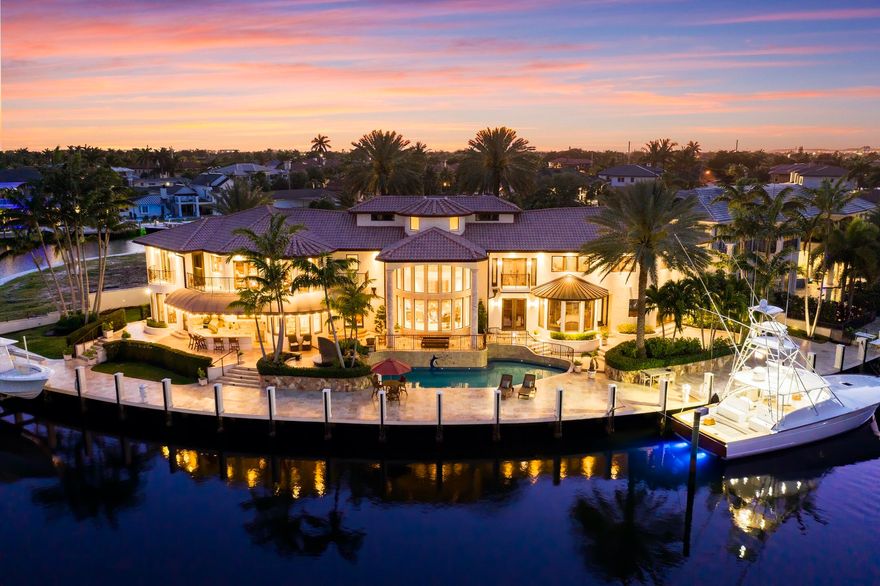 Exceptional gated estate tucked away on a quiet cul-de-sac offering ultimate privacy and waterfront living with 245 ft of deep water frontage. This one-of-a-kind custom home on an oversized lot offers 6 BR/6.5 BA with ample natural light, stunning great room atrium wall, impeccable design finishes and millwork. Complete with soaring ceilings, natural gas kitchen, state of the art home theater, library/billiards room, elevator, up and downstairs laundry, gym and sauna, and four bay garages. Expansive outdoor oasis with pool, summer kitchen and cabana bathroom built for entertaining, plus angler's room with direct access to the yacht dock. Located just minutes from Hillsboro Inlet and Atlantic Ocean.