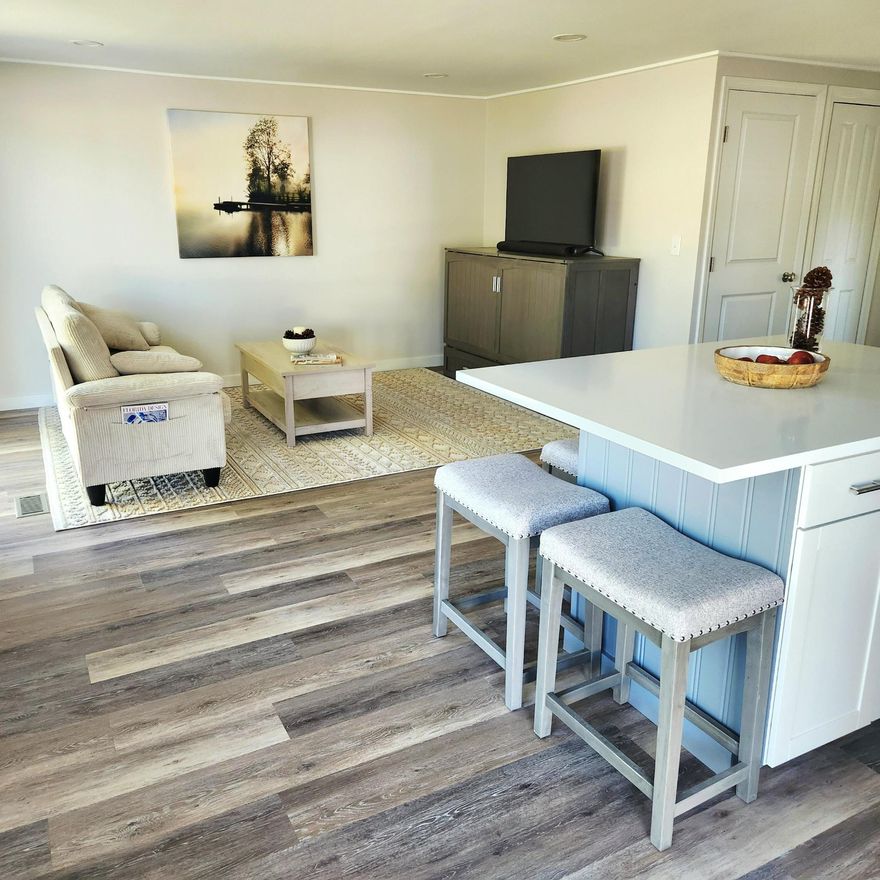 MUST SEE Fully Renovated, Furnished, Elegant, Modern Waterfront 2bed/2bath Open Concept w/ Premium 2025 Upgrades; Walled w/ 2x4 construction, New Sheetrock, Rockwool insulation w/ superior fire & sound resistant w/ mildew/rot/mold repellent. 2025 Improvements; brand new Shingle ROOF, New Skirting, Spray Foam Insulation, New VaporBarrier, Updated Plumbing, Reinforced Plywood Subflooring w/ Waterproof Vinyl Flooring. Kitchen w/ soft close drawers, 5ft Island w/ Storage, RecessedLights, EnergyEfficient Instant Tankless HWH & enhanced structural durability throughout. AC 2023. Lot lease 883.06-heated pool, security,Clubhouse w/activities, golf, bingo,pickleball, tennis,workshop,shuffleboard, bocce,gym,library,trash,lawn & more! Prime location; grocery,pharmacy,hospital,postal,mall,beach&more!