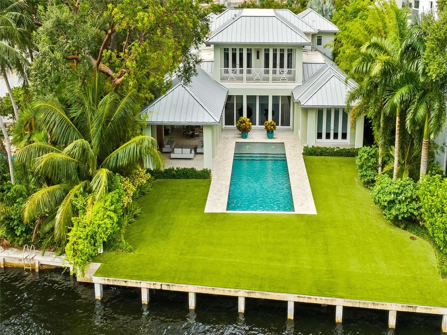 Experience the pinnacle of luxury waterfront in this exquisite 5BR|5.2BTH residence built by Bomar Builders. Nestled in a gated Las Olas neighborhood on prime waterfront with direct ocean access, it features a luxurious primary suite with a private office, perfect for work-from-home flexibility or a quiet retreat. The primary bath is a spa-like oasis with a separate shower, soaking tub, and double vanity. This property is designed for both relaxation and entertaining, featuring living areas with natural light and elegant finishes. The gourmet chef’s kitchen is equipped with top-of-the-line appliances, custom cabinetry and island, making it ideal for cooking and hosting. The seamless indoor-outdoor flow leads to a beautiful backyard with covered patio, outdoor kitchen and heated pool.