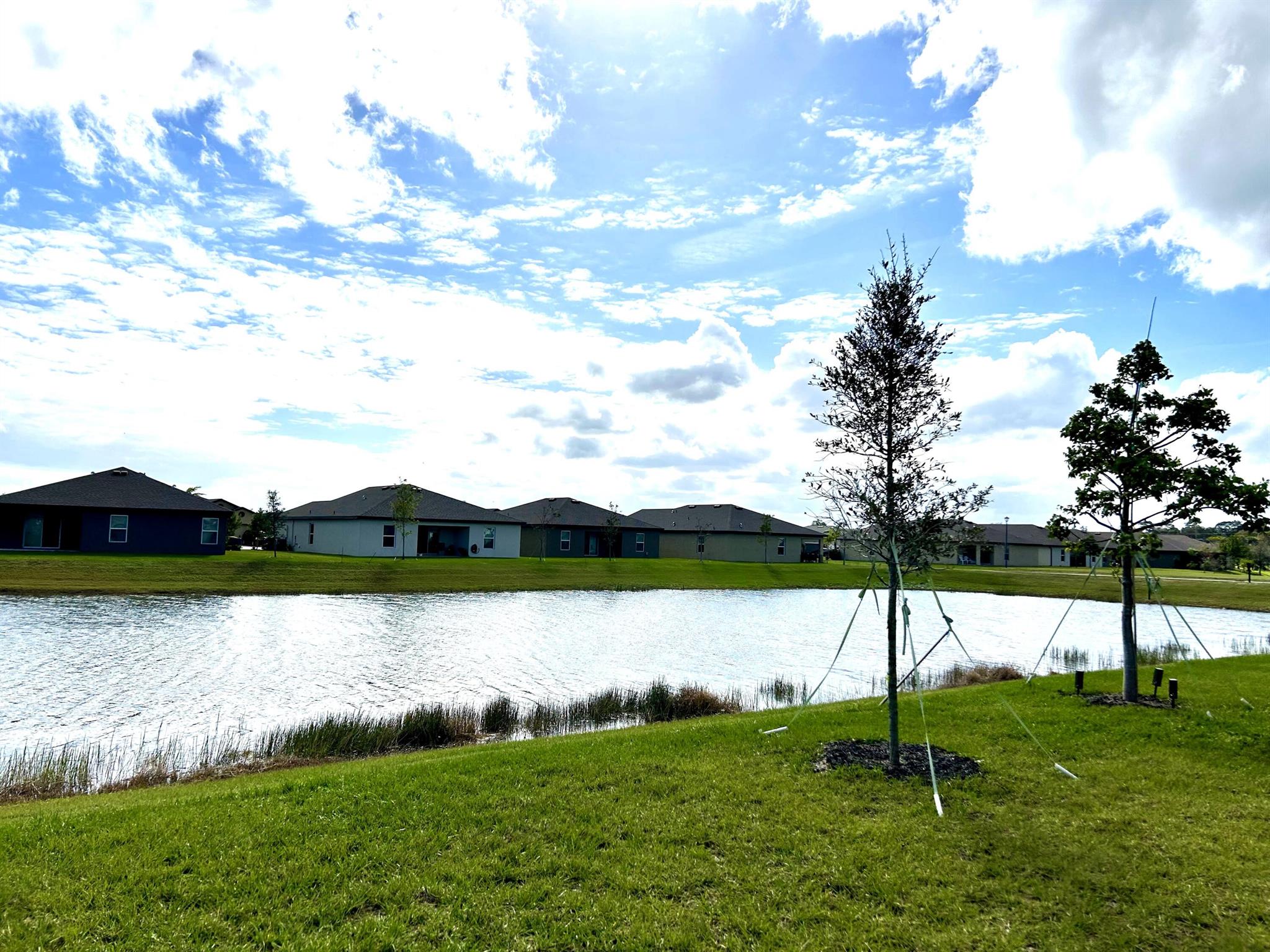 PANORAMIC LAKE VIEWS!! Newer 3 bedroom (possibly 4), 2 bath beauty! Once entering this great home, be greeted by sparkling, wide lake views! Open and spacious and the many windows and doors make this charmer bright and sunny. White kitchen with granite counter-tops, pantry, stainless steel appliances, a large eating bar and charming breakfast eating area. Great room design with a split floor plan. Pretty laminate floors with carpet in bedrooms. All 3 bedrooms are generously sized and the floor plan adapts to easily become 4 bedrooms. Master suite features large walk-in closet, with tub/shower combination in master bath. Great location, close to I95, Florida Turnpike and downtown Ft Pierce with its restaurants, marina and great farmer's market. Community pool playground, dog park.
