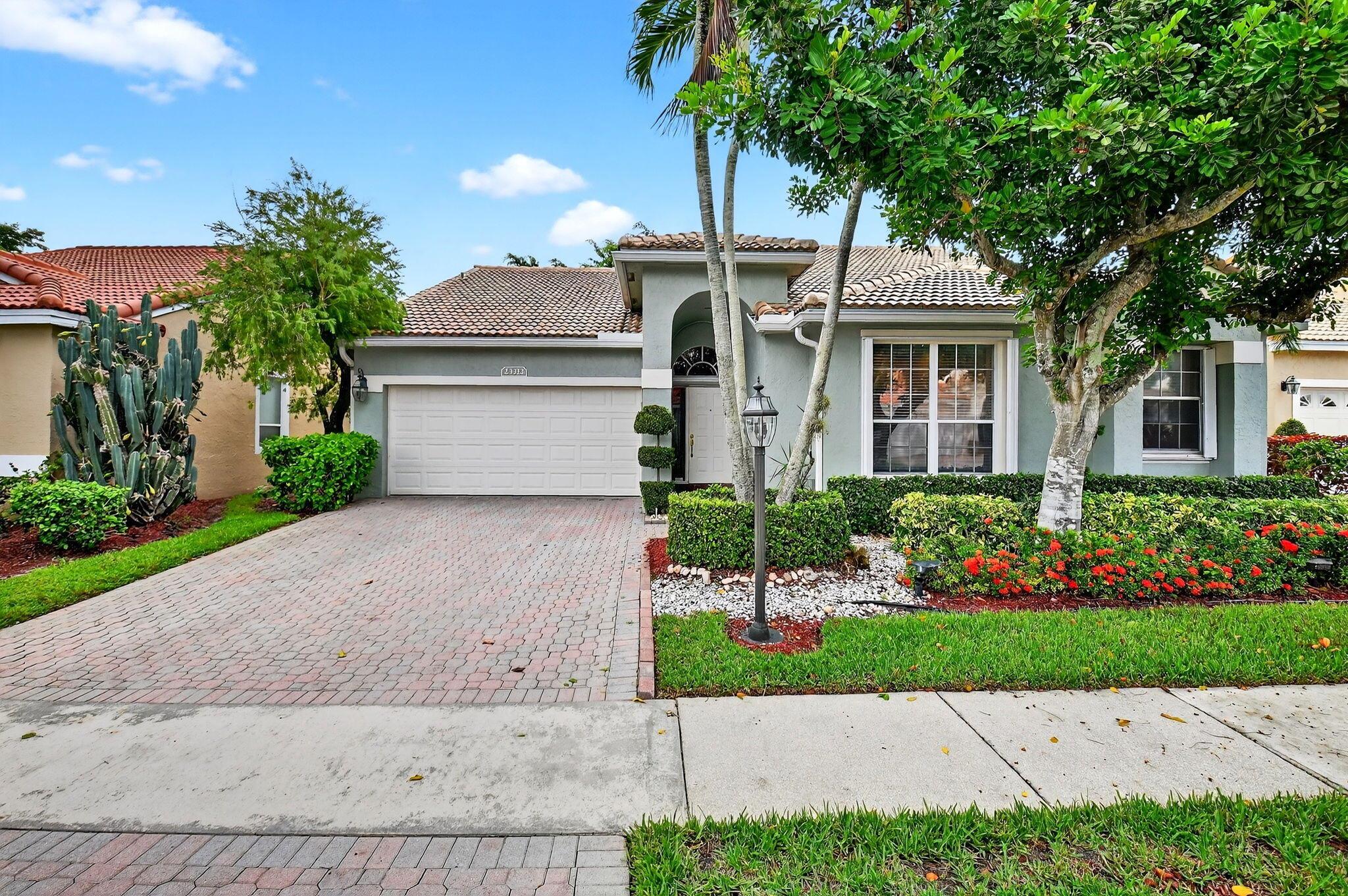 Custom one-story home in Costa Del Sol at Boca Pointe featuring 4 bedrooms, 2.5 baths, a formal living room, and a spacious family room. Enjoy the expansive private patio, with outdoor furniture included. Roof replaced in 2021, with A/C replaced in 2021 and water heater also replaced in 2020. Accordion shutters and panels protect all windows and doors. Elegant marble floors in main areas, with carpet in bedrooms. Updated bathrooms plus convenient extra half bath off the den. Additional highlights: central vacuum, garage storage, triple tray ceiling in living room, backyard turf, and updated kitchen with granite counters and white appliances. TV in den and 2nd refrigerator in garage all included. Community pool included!