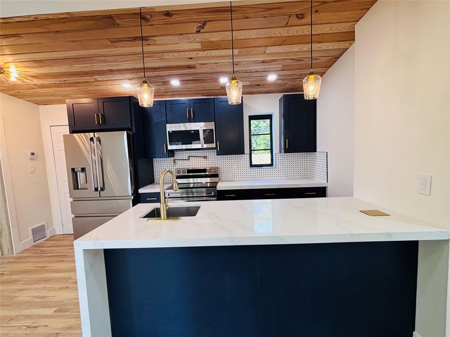 Beautifully 3-bed 2-bath single-family home offering a modern design and move-in ready comfort. This tastefully renovated property features durable water-resistant vinyl flooring throughout. The kitchen is a true highlight, showcasing a decorative wood ceiling that adds warmth and character, along with updated cabinetry and elegant quartz countertops. Both bathrooms are well maintained. Major upgrades include impact windows and a brand-new roof, offering added value and peace of mind. Step outside to enjoy a private patio partially turfed overlooking a large, fully fenced backyard with plenty of space for addition, pool, pets, or outdoor gatherings. This home perfectly blends style, functionality! Side door connects master bed which can be rented for extra income. Minutes to downtown Fort