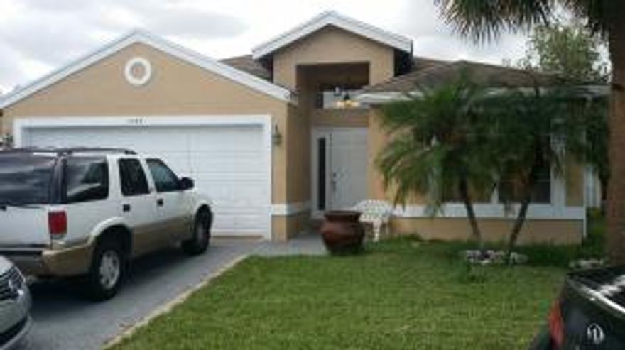 Nice SFH 3 bedroom/ 2 bath with split floor plan is light and bright. Open and spacious floor plan with vaulted ceilings, tile flooring throughout and split bedrooms, spacious kitchen with snack counter, CBS, two car garage, home is in good condition, in a gated community, close to the Wellington Mall, restaurants, and shopping center....don't wait too long!!!!!