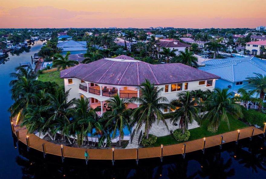 INCREDIBLE POINT LOT, OCEAN ACCESS, NO FIXED BRIDGES in desirable Venetian Isles! 167' Dock on deep, wide ''South Grand Canal.'' Straight shot to Intracoastal. Minutes to Hillsboro & Boca inlets.Brilliant 6 bed | 6.5 bath home, is set apart, with NEW tasteful, white chef's kitchen, SUB-ZERO fridge, Thermador gas stove, lrg pantry, travertine flrs, BONUS Rec/Media Room, coffered ceilings, built-ins, elevator, 2 laundries, gym, garages for 3 cars. Sonos sound, new saltwater pool system, new A/C.Grand Master includes dressing room, His/Her Baths, walk-in closets & room en suite serves as office or nursery. Expansive covered Patios & Balconies thoughtfully designed w/ cast stone details for entertaining and vast water views. Tropically landscaped for privacy.