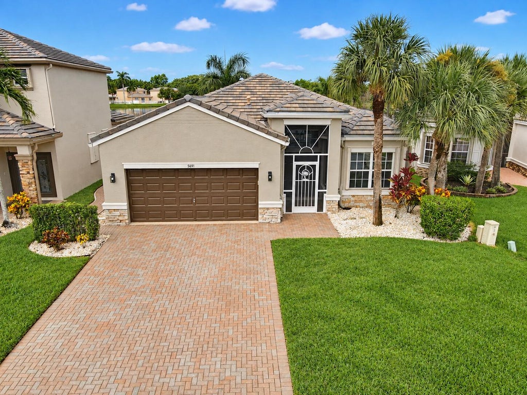 Photo of 5691 Saddle Trail Lane, Lake Worth, FL 33449 (MLS # B26074111)