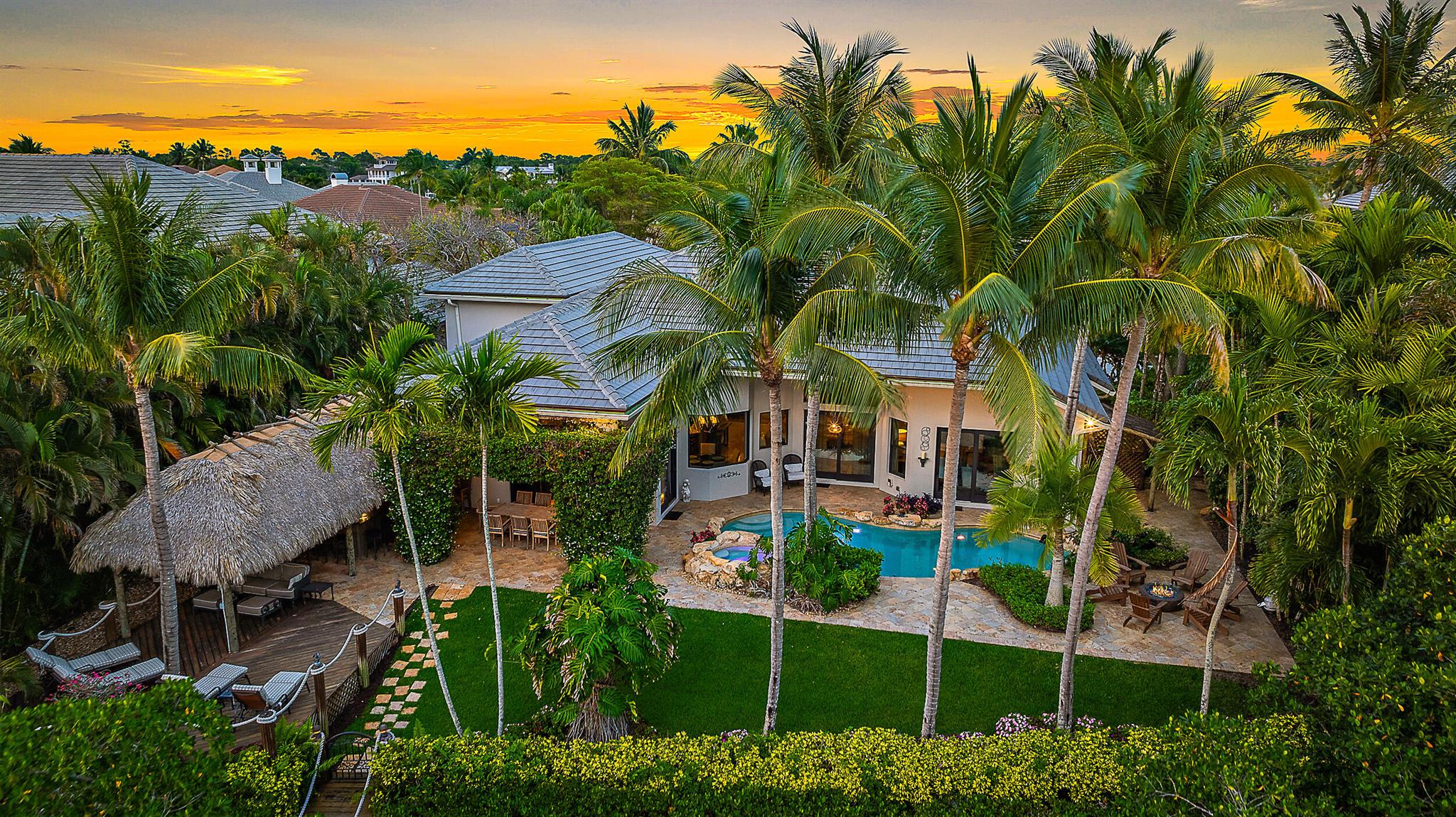 Welcome to your dream home! This beautifully updated property boasts clean lines and modern finishes throughout, creating a light and bright atmosphere that you'll love coming home to. Situated on a prime river location with ocean access, this house offers the best of the Florida Lifestyle. Backyard with Tiki Bar is ideal for entertaining, complete with a bar and fully equipped summer kitchen. Large windows and open spaces ensure plenty of natural light throughout the home. The kitchen is a chef's delight, featuring custom cabinetry, high-end appliances and elegant countertops. This is a true gem and a boaters paradise with a private dock.