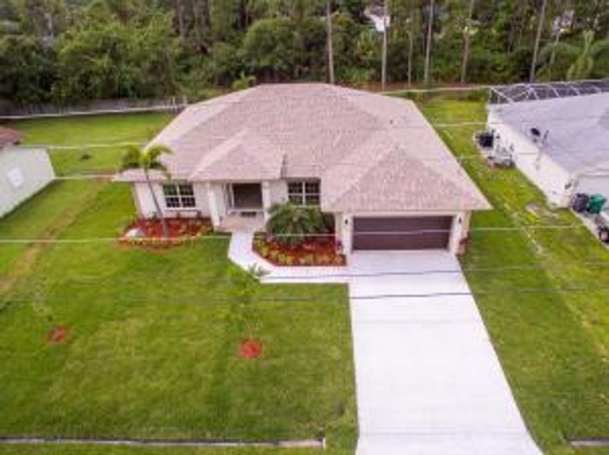 Opening the doors to your Dream Home ... Welcome Home! Boasting this stunning brand new 4/2/2 well appointed home on a nice lot with private backyard and small canal with a nice cover porch.  It is all in the details, from the double glass door entryway to the large bright and open floor plan with 24'' marble tile in living areas, a gourmet kitchen with 48'' cherry wood cabinets with granite counter tops and stainless steel appliances. A spacious master bedroom with tray ceilings, berber carpet in bedrooms and sharp wood laminate flooring in the front bedroom that can also be used as a den or office. OH and how about the bathrooms with a modern look, a nice irrigation system.  So much more and the list goes on ..... you will not be disappointed! Home includes 1 year builder's warranty!