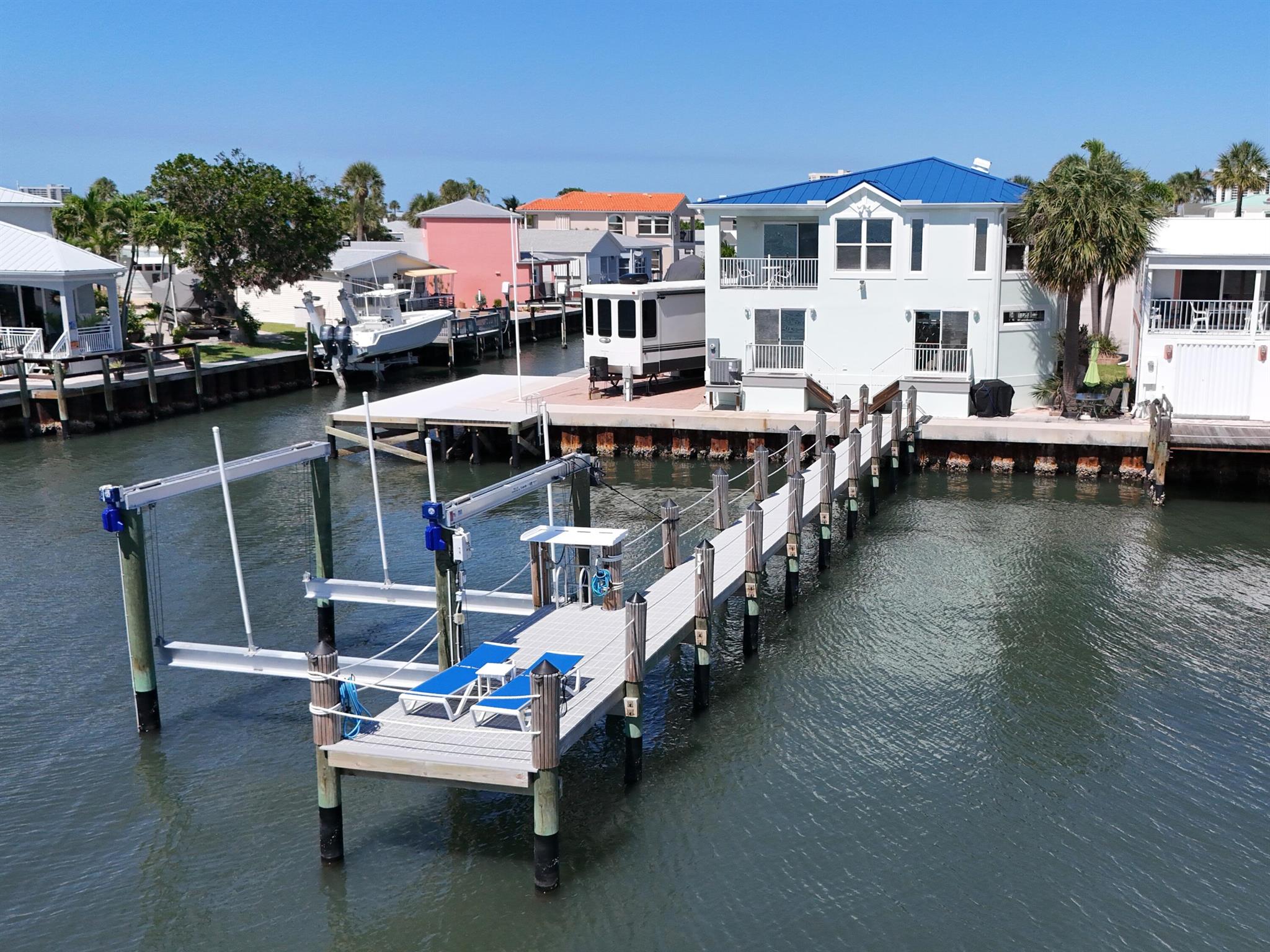 Waterfront living at its best! This 2BD (potentially 3), 3BA, fully-furnished home offers 45 FT of direct Intracoastal frontage with a brand new 90FT dock with deep water access, composite decking, and 24K LB lift--ideal for serious boaters. Two nearby inlets make it easy to hit the open water. Enjoy stunning Intracoastal views and gorgeous sunsets from your backyard. The home features a new standing seam metal roof, new stainless steel appliances, and partial impact glass. The lower level is set up as a guest suite with a separate kitchenette easily convertible to a third bedroom. Perfect as a full-time residence, vacation home, or short-term rental. Life on Nettles Island feels like a permanent vacation, with everything you need just steps from your door. Residents enjoy resort-style