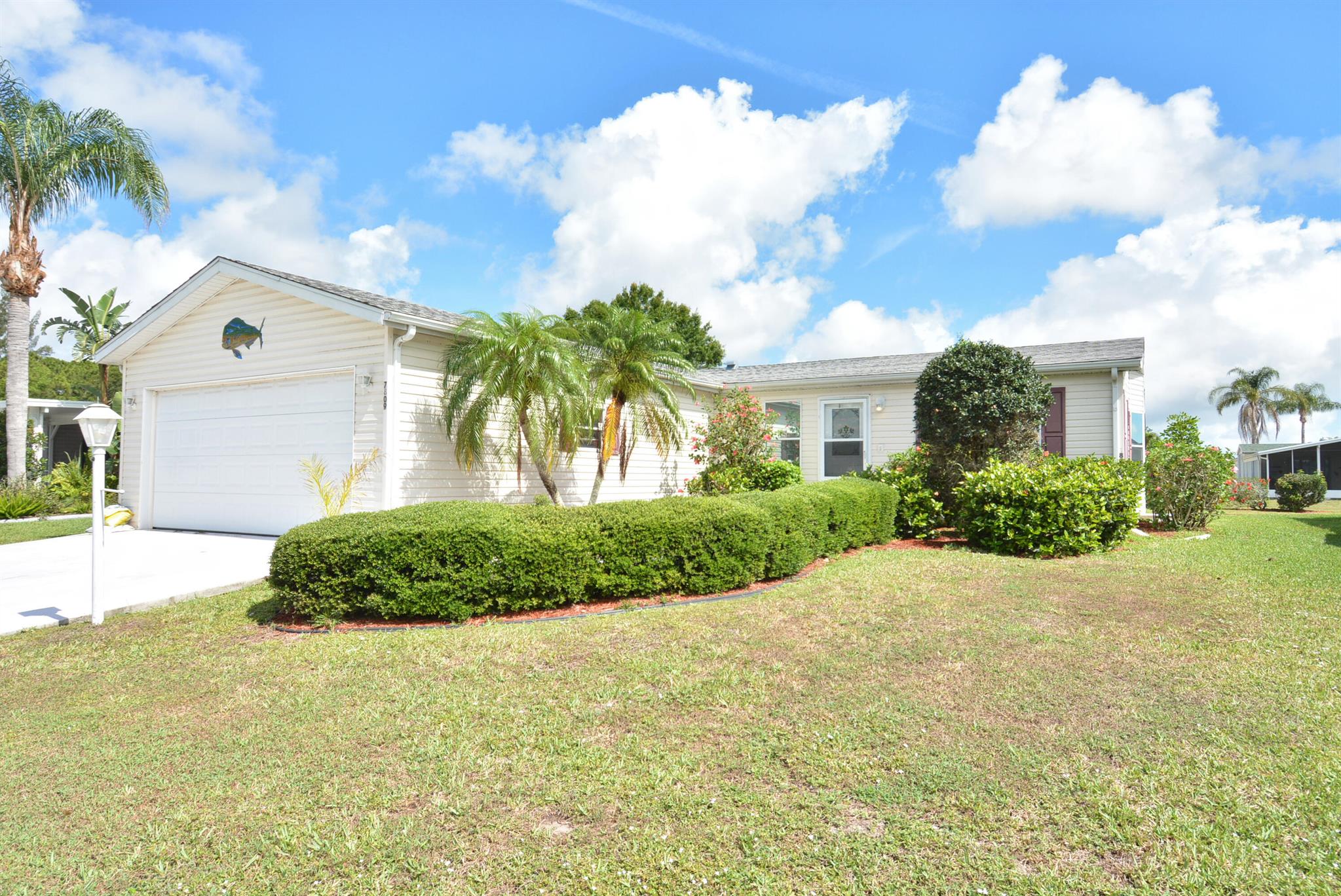 In the 55 plus community of the Savanna Club, 16 minutes from the beach we have for sale a 3 bedroom 2 bath 2 car garage with an enclosed lanai! SO many upgrades, real windows, stainless steel appliances,! This could truly be your home in paradise! This land lease property is ready for someone to make memories with!