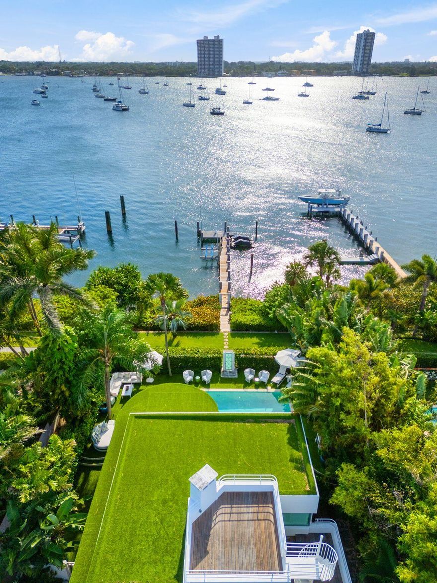 A beautifully renovated, masterful landmark of Modernist architecture, the Boat House combines the very best elements of life in Palm Beach - the perfect spot on the lakefront with dock and boat-lift, deeded ocean access at the Mockingbird neighborhood beach cabana, and an incredibly elegant, exquisitely renovated, move-in ready home. This nautically themed Art Moderne home faces prow-forward toward dramatic sunsets, its rooftop deck overlooking the pool, dock and sparkling Intracoastal. Sea-going touches include seamed hardwood floors, porthole windows and white-piped terrace railings. The house received a full renovation a few years ago and the current owners then made meaningful improvements of their own.