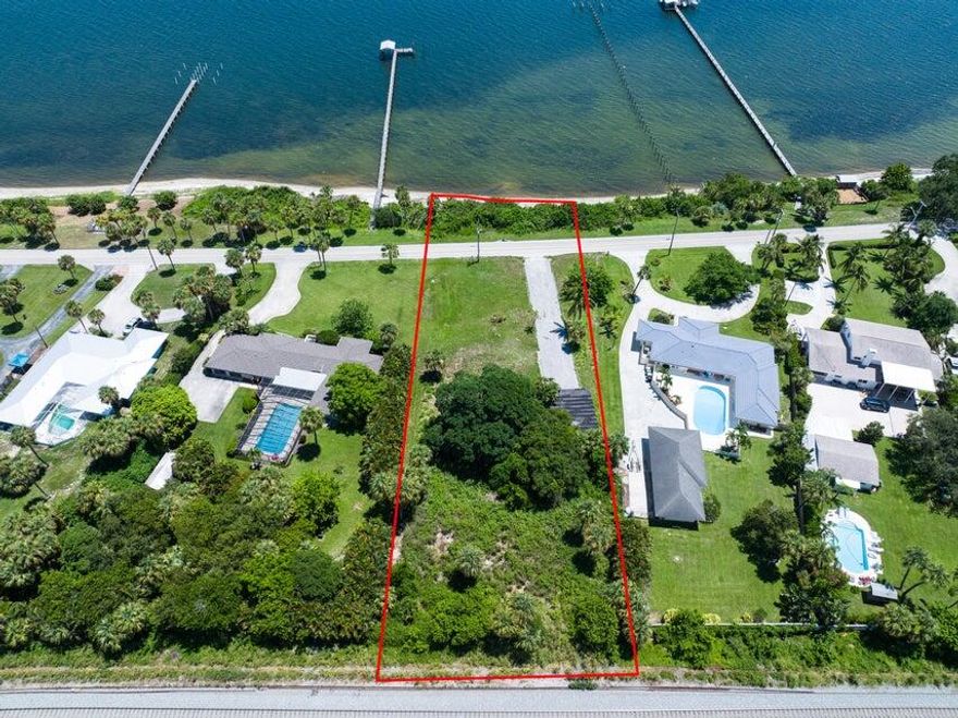Discover your dream waterfront home site on Indian River Drive, located on Florida's Designated Scenic Route! This stunning property offers 150 feet of deeded waterfront, providing you with the perfect canvas to build your dream home. Imagine waking up to breathtaking views every day! Ocean access is made easy via the Fort Pierce Inlet, just 2 miles away, making it convenient for boating enthusiasts. The Indian River lagoon, one of North America's most biologically diverse estuaries, offers an incredible ecosystem to explore and enjoy. At low tide, you can take advantage of the sandy beach, perfect for paddle boarding or fishing. Experience the best of Florida living with great elevation, allowing for amazing wide riverfront views. see supplement for more information Historic Fort Pierce is nearby, offering a vibrant community with fantastic restaurants and the renowned Saturday Green market. The historic Sunrise Theatre provides cultural entertainment at its finest.

City water is available, and an artesian well is on site for irrigation. Plus a 2-car garage is on the property.

Located in the prestigious section of Indian River Drive, where some homes are valued at over $5 million, this property is truly the crème de la crème of waterfront living. Don't miss this incredible opportunity to experience the epitome Treasure Coast luxury living!

There used to be a home on this property, so potential for savings on impact fees. A number of beautiful mature trees including many varieties of Palms are on the site.

1.2 acres per survey (.92 acre West of IRD and .3 acre on the River).