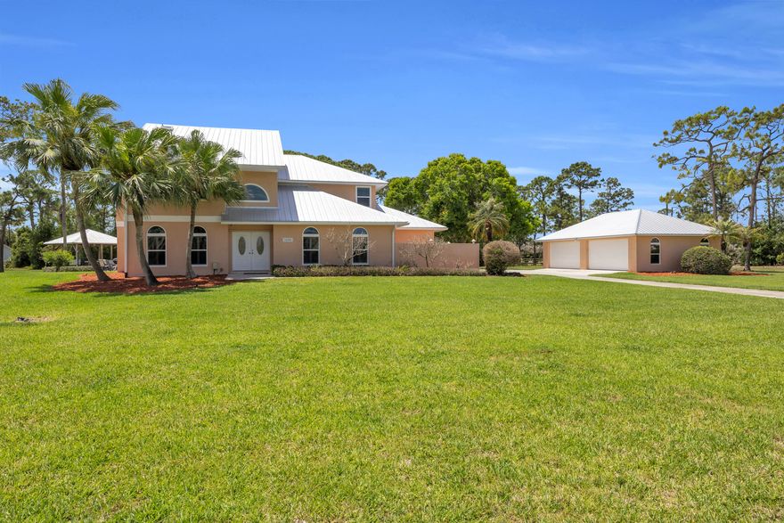 Beautiful CBS pool home on 4.4 acres in the highly sought-after Stuart West equestrian/acreage community in Palm City!  Over 4,100 living sq ft with 4BR/3BA + FLEX room (optional 5th). Features include a spacious layout, detached 4-car garage (1,000+ sq ft), impact windows, plantation shutters, and updated primary suite. Enjoy outdoor living with a pool, new screen enclosure (2025), and hot tub pavilion under a custom tiki hut, surrounded by mango, lime, and coconut palms. Major updates include a metal roof (2024), A/C (2024), a pool pump (2025), a new well pump, water system upgrades, and septic pumping (April 2026). Additional features include a storage shed and a dual-fuel generator with an interlock kit. Stuart West offers equestrian amenities, boating, golf, dining, and more!  Private, peaceful setting just minutes to highways, shopping, and dining.