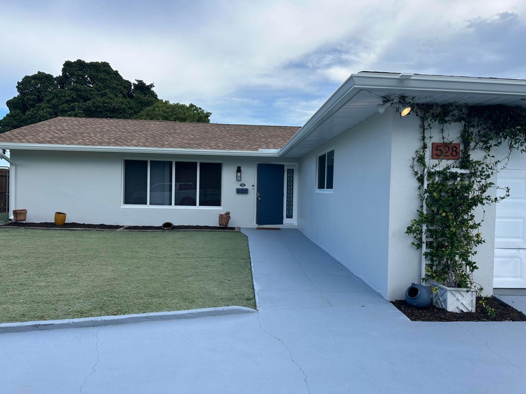 Photo of 528 Date Palm Drive, Lake Park, FL 33403 (MLS # B26047694)