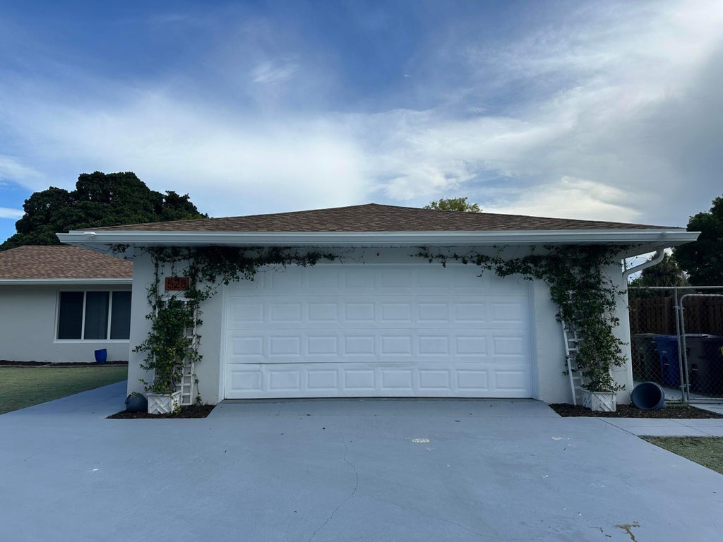 Photo of 528 Date Palm Drive, Lake Park, FL 33403 (MLS # B26047694)
