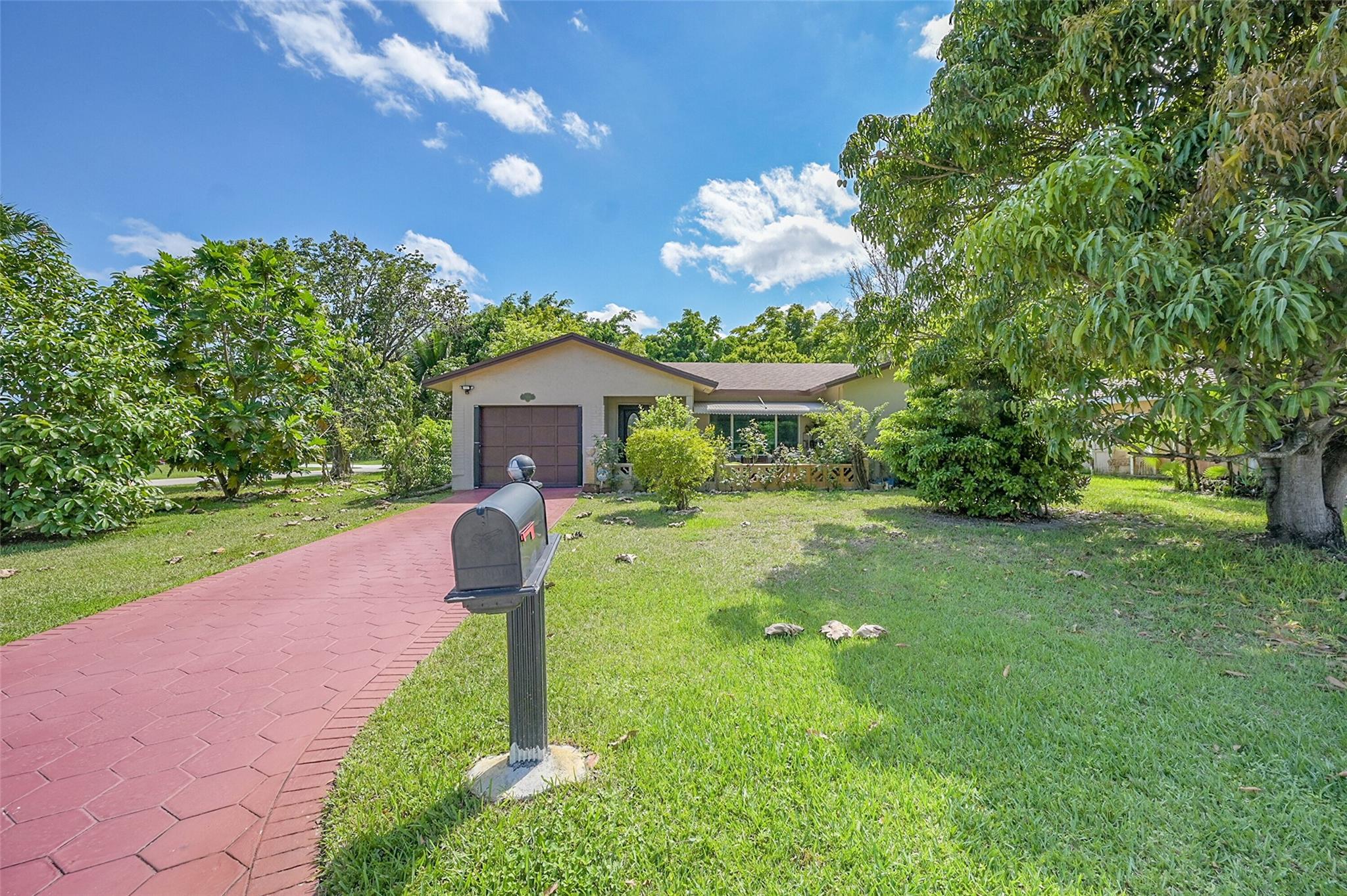 Beautiful Corner Home with Updated Modern Kitchen, Impact Windows & Tropical Garden Oasis!
This well-maintained home features impact windows and doors, providing energy efficiency and storm protection. Enjoy peace of mind with a 2017 roof and A/C, plus a tankless water heater that's just two years old. The modern kitchen boasts stainless steel appliances (only two years old), and a Samsung XL washer (2 years old) adds modern convenience. Garage converted to 3rd bedroom. Outside, the property is a tropical paradise, surrounded by fruit trees including mangoes, cherries, pomegranate and SO MUCH more—perfect for anyone who loves fresh, organic, homegrown produce. A rare find with thoughtful upgrades and lush surroundings with butterfly garden!