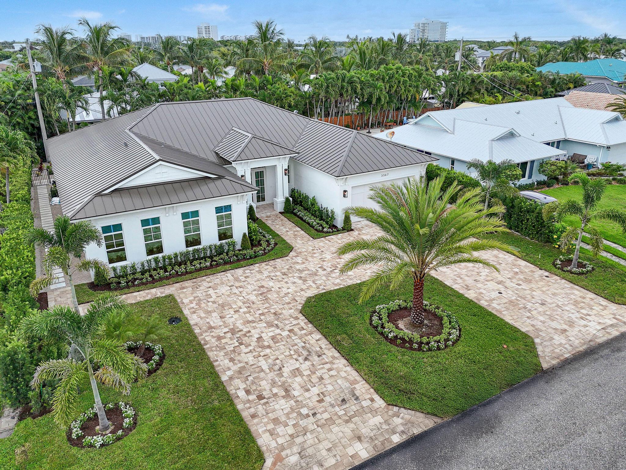 Stunning, new construction home in Waterway Village, a sought-after Intracoastal neighborhood. This 6-bedroom, 4.5-bath residence offers over 3,000 SqFt of beautifully designed living space and 3,800+ total SqFt. The coastal-inspired exterior features a crisp white facade, metal roof, paver driveway, and lush tropical landscaping that creates a striking first impression. Inside, the open great room is the centerpiece of the home, flowing effortlessly to the covered patio and private pool for seamless indoor-outdoor living. The bright white kitchen pairs perfectly with wide-plank oak wood flooring and modern finishes, while large windows fill the home with natural light. Thoughtful details include a spacious laundry room, two-car garage, and a versatile floor plan designed for comfort and