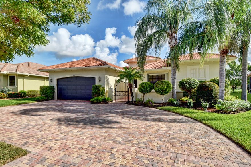 Gorgeous and elegant are two of the many words that can describe this highly upgraded lake view pool home.  Imagine how impressed your guests will be as they drive on to your brick pavered circular driveway, then walk through the front entry gate with additional pavered sitting area inside the privacy wall. When they enter the home, they will be impressed by the view as they look out 10 foot windows to see your beautiful walk in pool and tranquil lake. The interior of this magnificent home will take your breath away.  High quality dark wood floors throughout the living area and kitchen provides a richness worthy of the affluence of the rest of the home designs.  The second and third bedrooms, and den, have been extended 3 feet, adding an additional 100 sq. ft. of living space. The sophisticated ceilings in the Great Room, Dining Room, Kitchen and Den will surely draw the attention of your guests and family.  This Great Room home is the perfect home to entertain your family and friends. The kitchen is open to the Great Room allowing for easy conversation and access.  If you enjoy the culinary experience, you will love this kitchen equipped with high end stainless steel appliances including a French Door refrigerator that is less than one year old.  Granite countertops with granite/tile backsplash and undermount sink, cherry wood cabinets (with self closing drawers) and spacious breakfast area add a richness to the kitchen like none other.  The voluminous master suite has room for any size bedroom set and still room for a sitting area worthy of your relaxation before retiring for the evening.  The master bathroom has dual vanities, granite counters and a separate bath and shower with full body wash sprays.  Enjoy spending time in your den, with electric fireplace and library.  A newer washer and dryer completes the laundry room.  If that isn't enough, you will be amazed with the high end window treatments, lighting fixtures and ceiling fans that are featured throughout the home. Enjoy entertaining?  With the large Great Room area and the resort style back yard, you will have fun throwing parties for your family and friends.  The salt water walk in pool, tumble stone marble pool deck, spacious yard, and beautiful view of the lake (with fountain) completes the resort atmosphere the outdoor environment of this home provides.  While the list price of this home is based on taking ownership unfurnished, all furniture is negotiable, thus providing the fortunate buyer a turnkey opportunity.  Four Seasons at Delray Beach is an intimate community of 315 homes offering many clubs and activities including a State of the Art Fitness Center, 6 har-tru tennis courts and beautiful clubhouse.  Pickle Ball courts will soon be installed as well.  Located in desirable west Delray Beach, the community is just a short drive to the popular Downtown Delray Beach and just a few minutes to the Delray Marketplace.  Don't miss this opportunity to see this rare find of a home.  You will not be disappointed.  Note:  Buyers are responsible for paying a one time, non-refundable capital contribution at closing equal to 3 months of HOA dues.