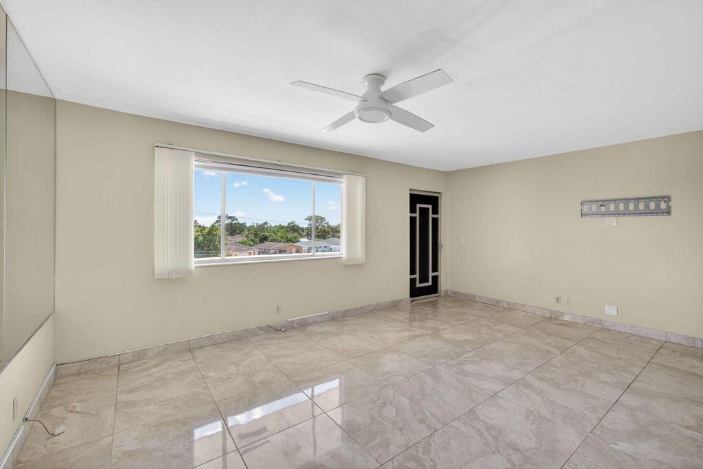 Photo of 300 S Village Green Cir Circle S #420, Palm Springs, FL 33461 (MLS # B26026614)