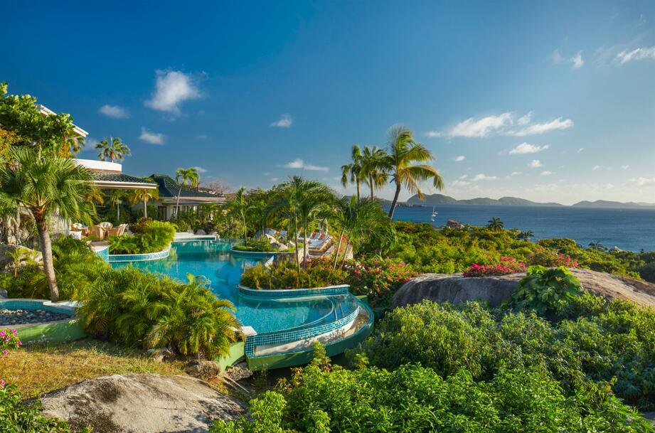 Refined resort-style living awaits at this recently renovated Virgin Gorda, British Virgin Islands generational 'Valley Trunk' enclave on landscaped 18 freehold acres with 1,100+/- feet of Caribbean white-sand beachfront, overlooking dazzling Sir Francis Drake Channel views. Living areas of the ten-bedroom villa open to the freeform 80-foot infinity pool, while the tennis court adjoins the four-bedroom guest villa. Features include a modern interior redesign with a coastal aesthetic; cinema screening room; lounge with a wet bar; luxe primary suite offering panoramic views of the ocean, islands and sunset; separate manager's house-staff accommodations. wander garden pathways to explore your property's flora and fauna, play in the rock pools, snorkel in dramatic underwater seascapes!
