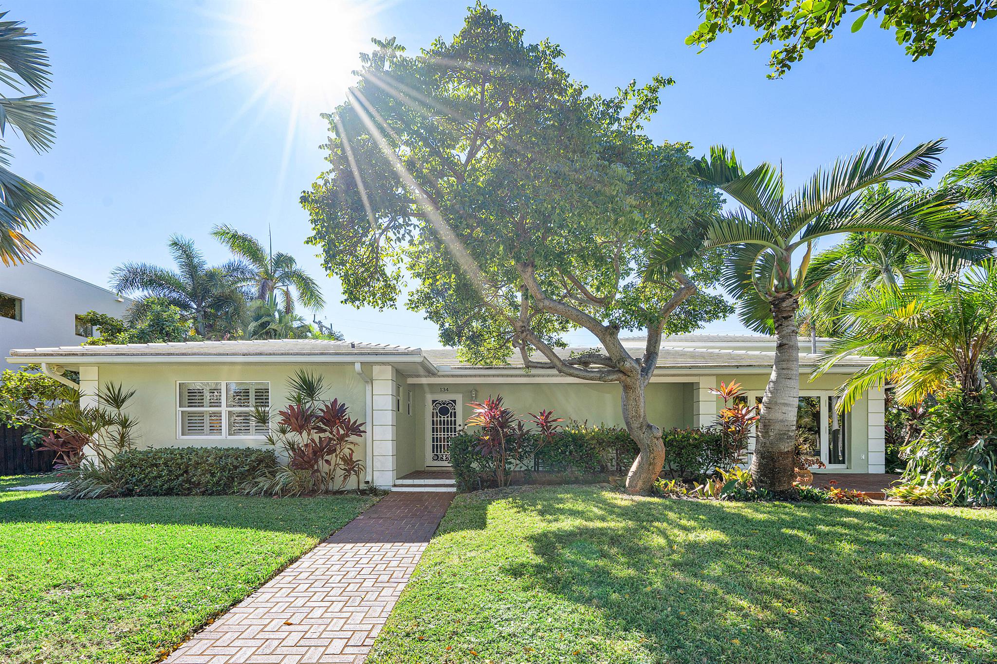 Charming pool home in lake block prime location in SoSo. A corner lot on an attractive street with sidewalks just steps from the Intracoastal Waterway. Convenient to downtown West Palm Beach and Palm Beach, in the South Olive school district. Ground floor primary bedroom suite has it all: walk in closet, en suite bathroom and den/sitting area opening out to the pool area. The home offers a second bedroom with en suite bathroom on ground floor. The upstairs will surprise you, with two bedrooms and bathrooms, a spacious family room and kitchen: perfect for guests, mother-in-law suite, older children. Solid CBS construction, with a cement tile roof, and original terrazzo floors in ground floor living areas. Two-car garage, impact windows and so much more.