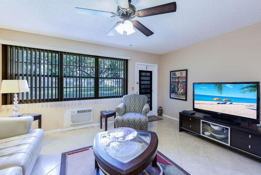 Delightfully furnished 1 bedroom 1 bath ground floor condo facing peaceful courtyard ,ready to move in just bring your toothbrush. Comfy and updated with impact resistant windows in Florida room. Remodeled kitchen with tile floors and popcorn removed from ceiling and in updated bathroom. A/C in living room and bedroom 2 years old. All artwork and everything included. Come enjoy this tropical Florida life style in a gated community, only 3 miles from the beach. HOA includes water, sewer, cable tv, yard and outside building maintenance, pool, game room , pool tables, theater w/live shows (and Free Movies) library, a myriad of art and other classes . Free busses to take you shopping, doctors, and shopping ETC. Seller offers $3000 credit for h/w heater and upgrade wiring with full offer