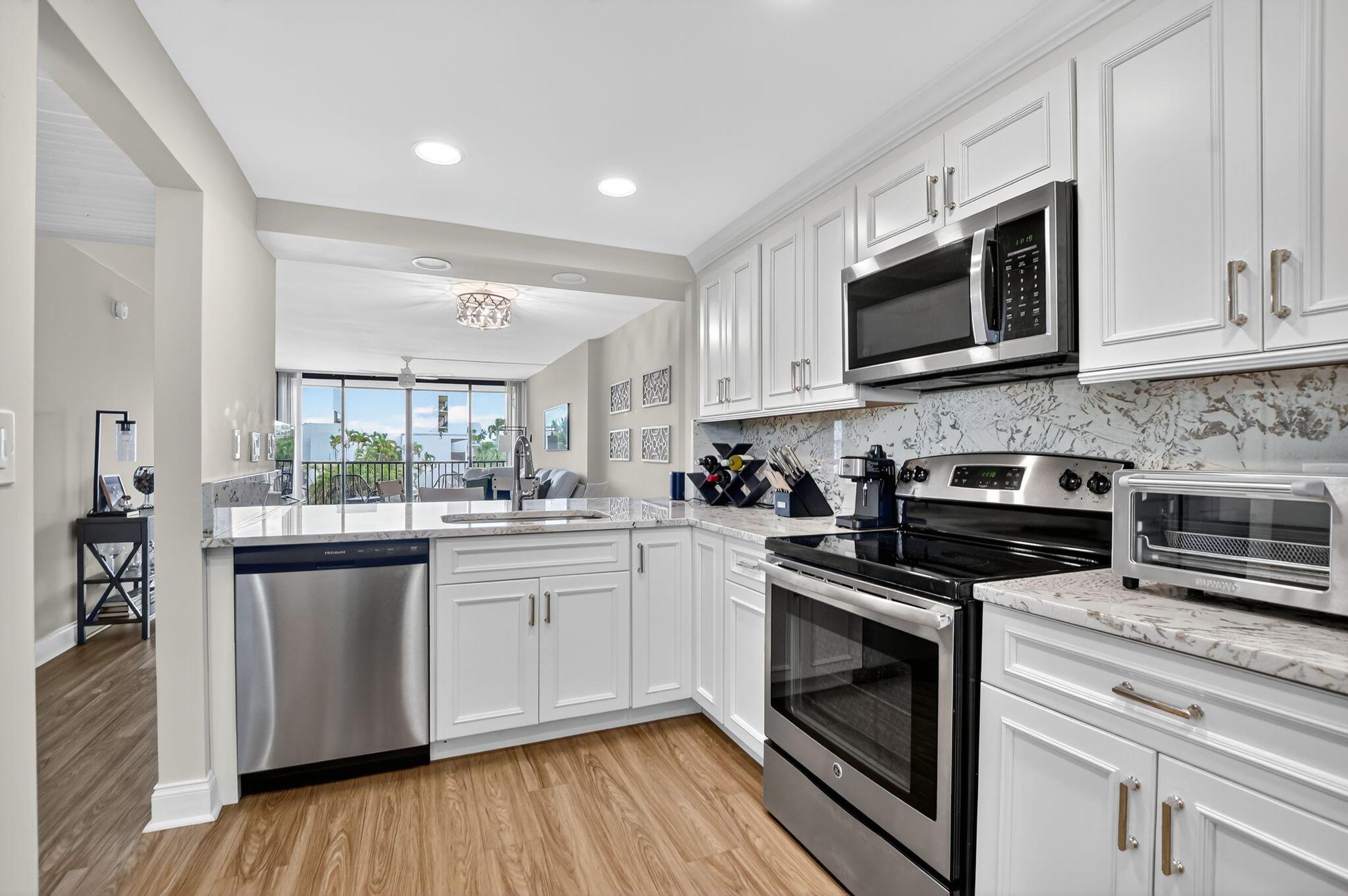 Experience waterfront living in this beautifully updated 2-bed, 1-bath condo, located in the highly desirable community of Boca Bayou. Enjoy views of the marina and pool from your private screened balcony. Notable features include laminate flooring, granite countertops, custom cabinetry, stainless steel appliances, large walk-in closet and extra storage locker. Furniture is also negotiable with sale! Unit can be rented straight away - perfect for investors. Condo fee includes cable with HBO, water, building insurance, reserves and 24hr security. Community has completed 30-yr Concrete Recertification & Structural Integrity Reserve Study. Clubhouse renovation special assessment has already been paid in full by the seller.